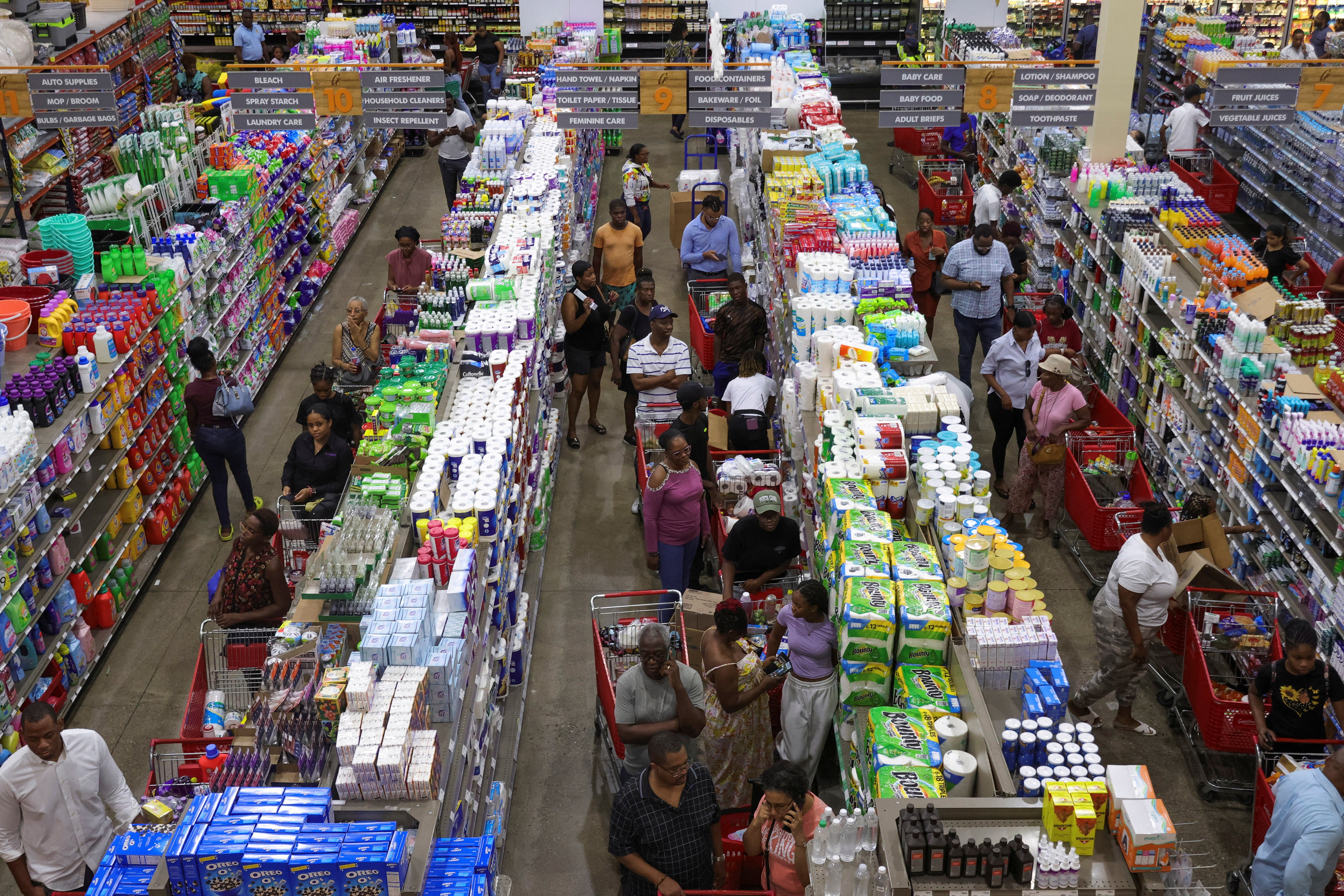 People wait in line with groceries ahead of the arrival of Hurricane Beryl, in Kingston, Jamaica, July 1, 2024