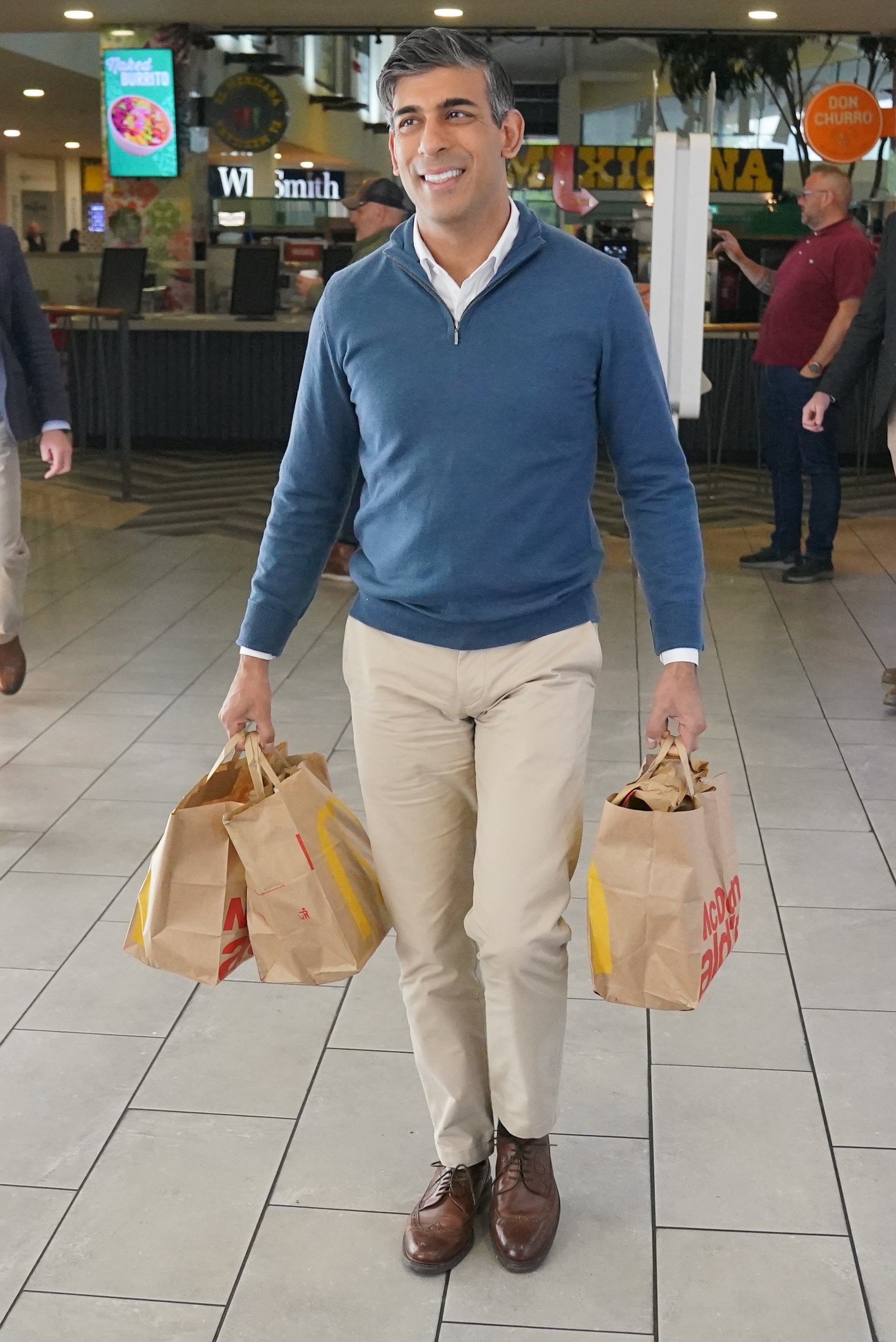 Rishi Sunak emerged from McDonald’s with several bags (Jonathan Brady/PA)
