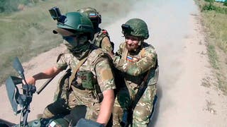 In this photo, taken from a video released by the press service of the Russian Defense Ministry on Monday, July 1, 2024, Russian soldiers drive an ATV changing positions on the front line at an undisclosed location in Ukraine.