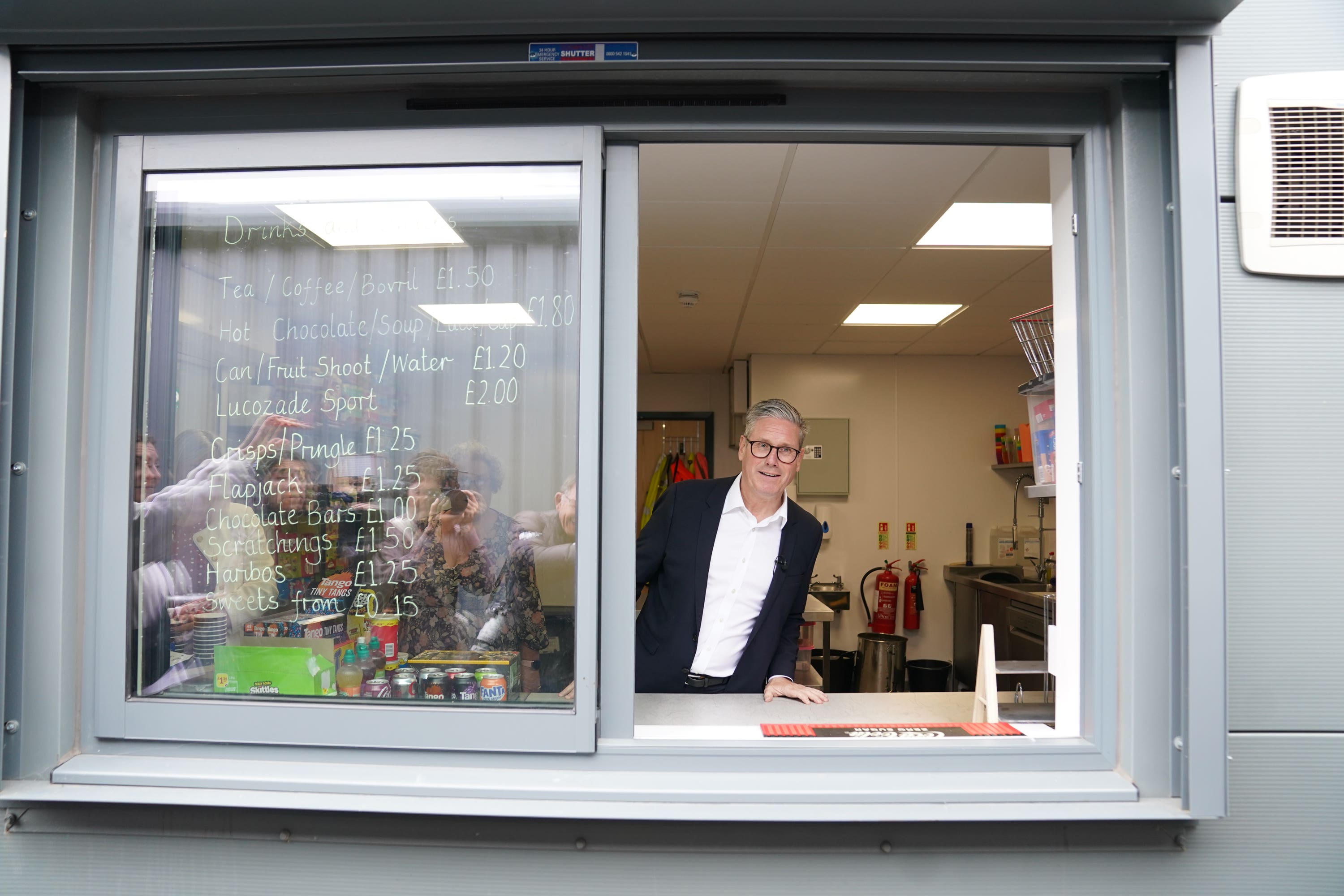 Labour Party leader Sir Keir Starmer serves drinks during a visit to Hucknall Town FC in Nottinghamshire, while on the campaign trail (Stefan Rousseau/PA)