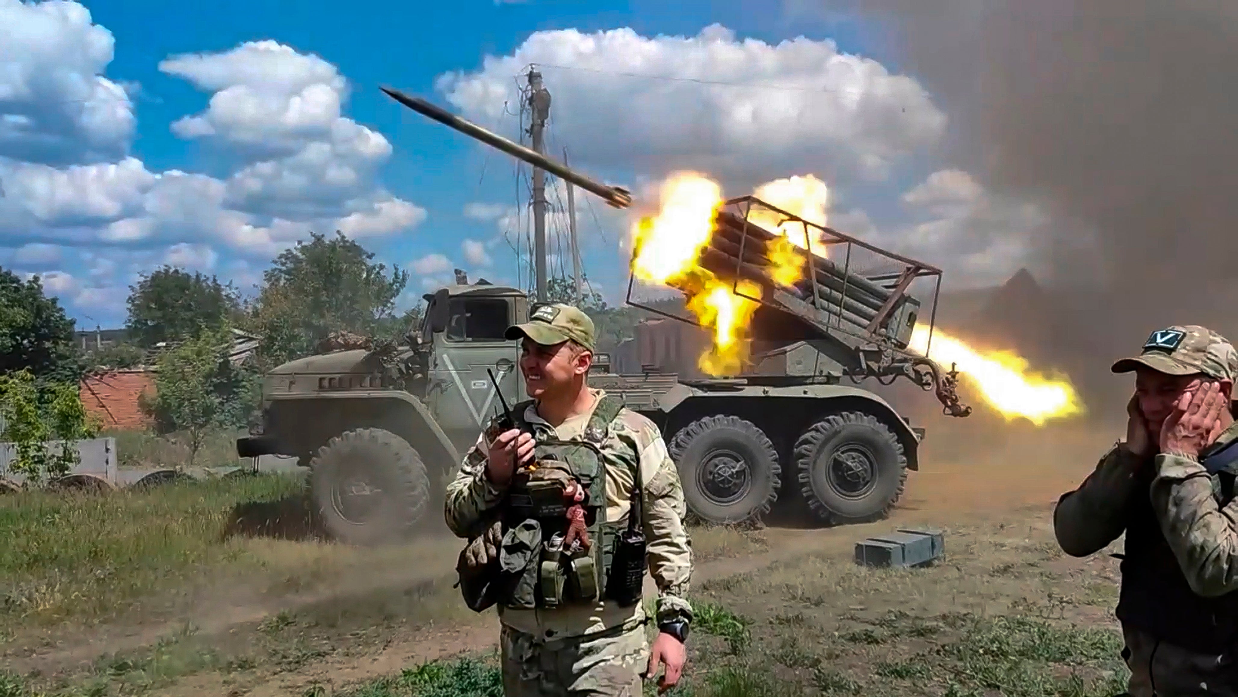 Russian soldiers fire from the BM-21 “Grad” self-propelled 122mm multiple rocket launcher in an undisclosed location in Ukraine