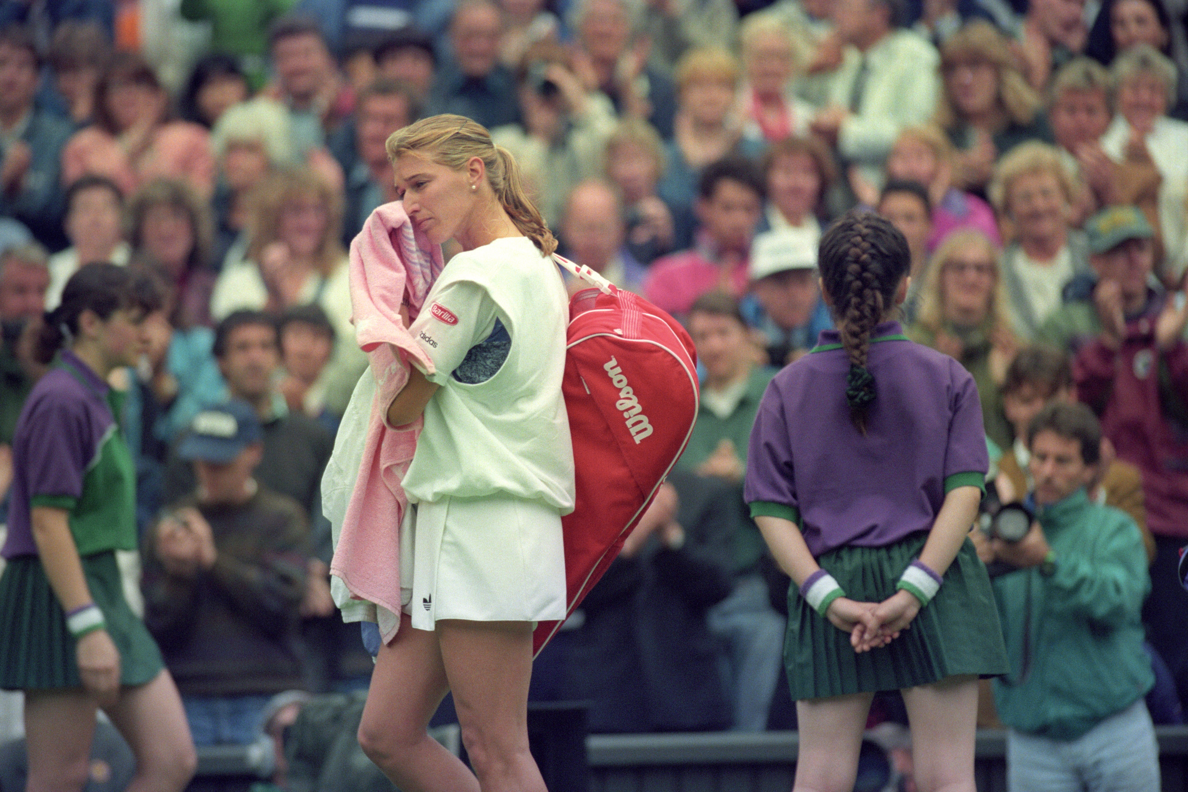 Defending champion Steffi Graf leaves Centre Court at Wimbledon after losing to Lori McNeil (PA)