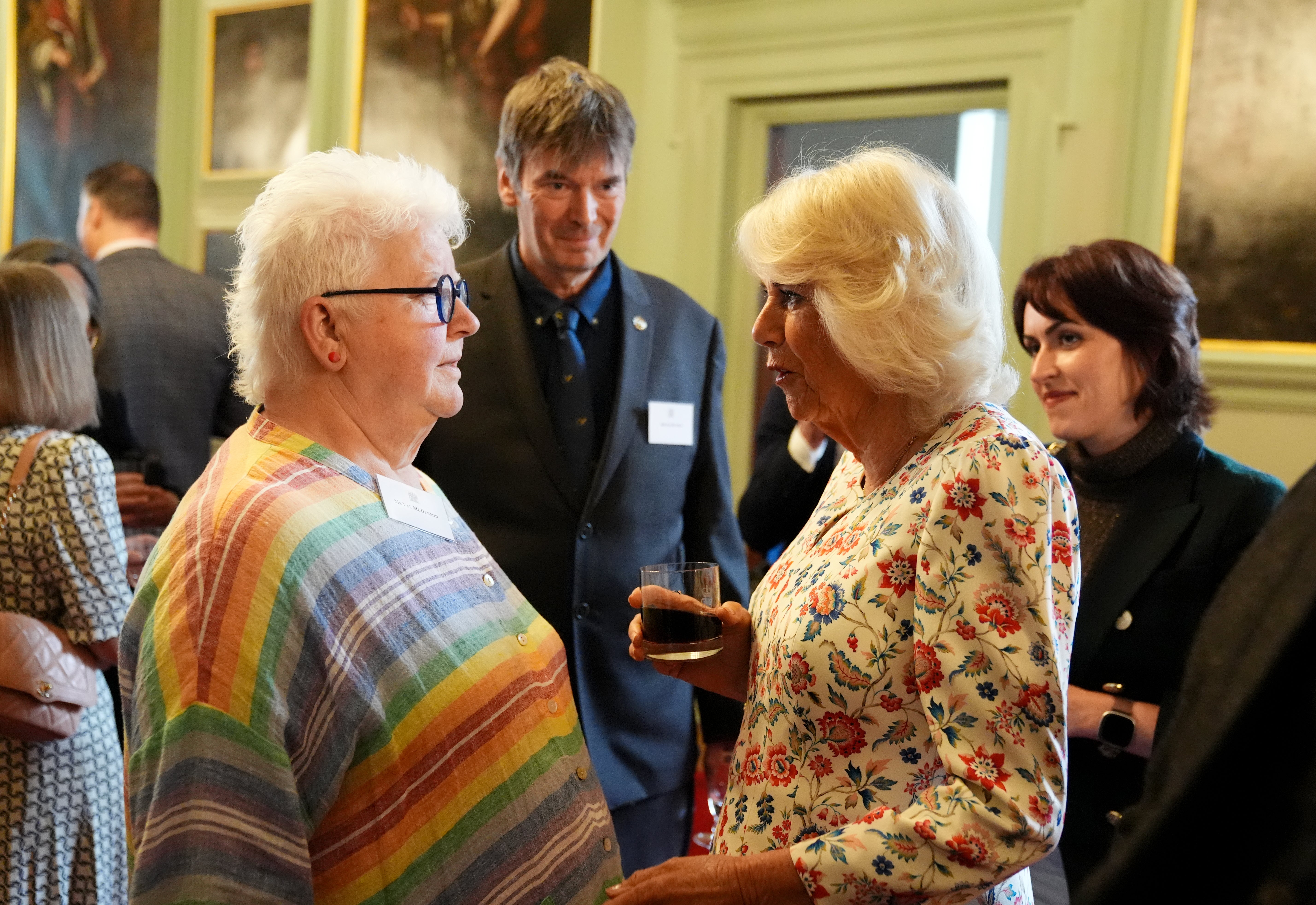 Camilla speaks with crime writer Val McDermid (left) as Sir Ian Rankin (centre, rear) looks on (Andrew Milligan/PA)