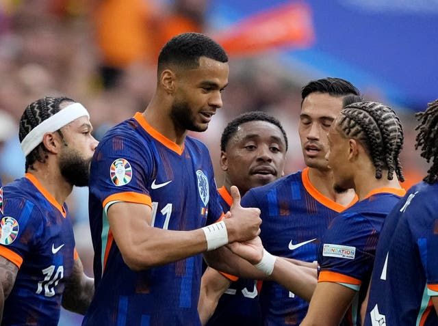 <p>Cody Gakpo celebrates with Xavi Simons after scoring the first Netherlands goal in Munich’s Allianz Arena </p>