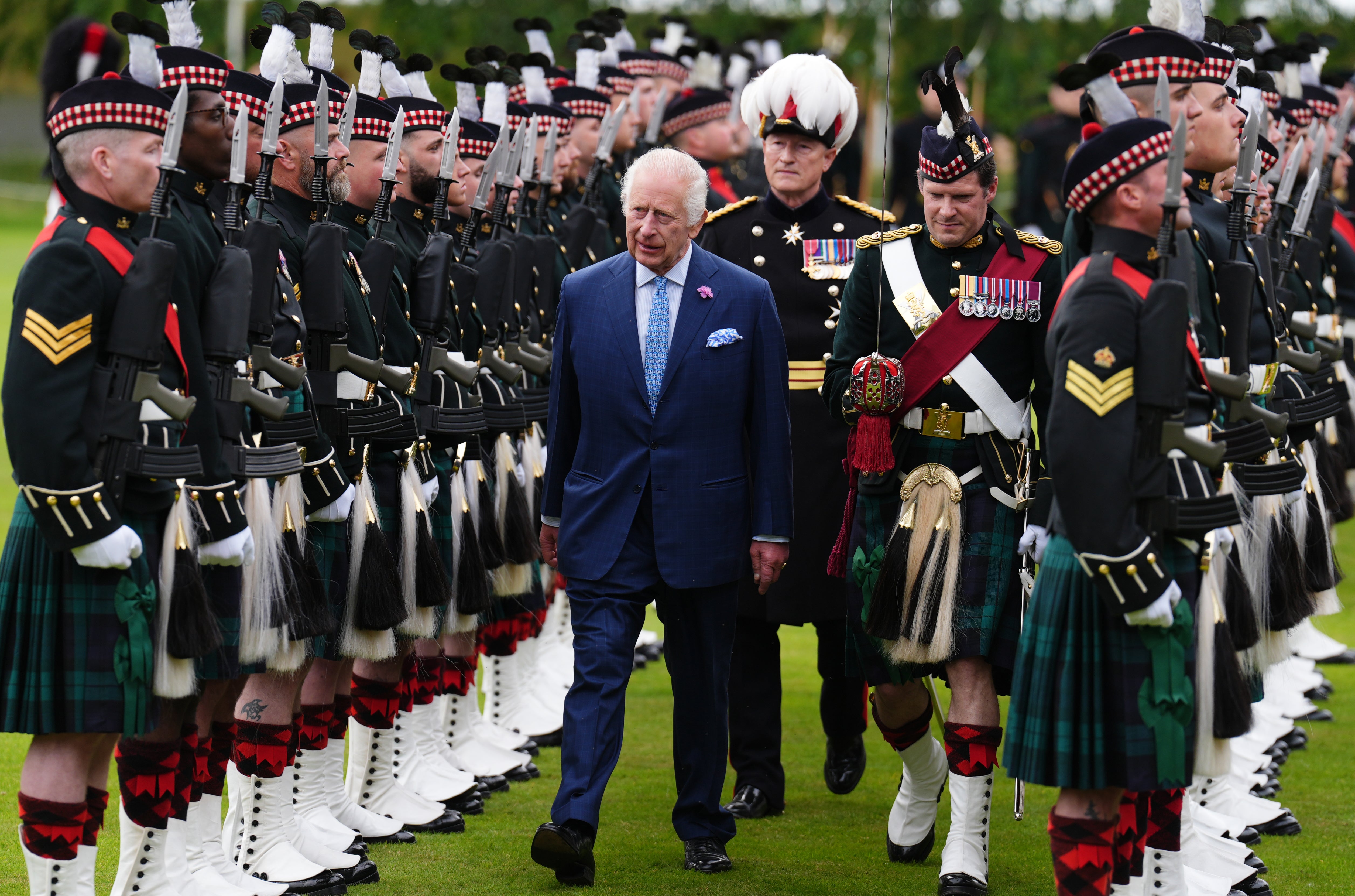 Charles walks through a guard of honour in the Ceremony of the Keys on the forecourt of the Palace of Holyroodhouse in Edinburgh (Andrew Milligan/PA)