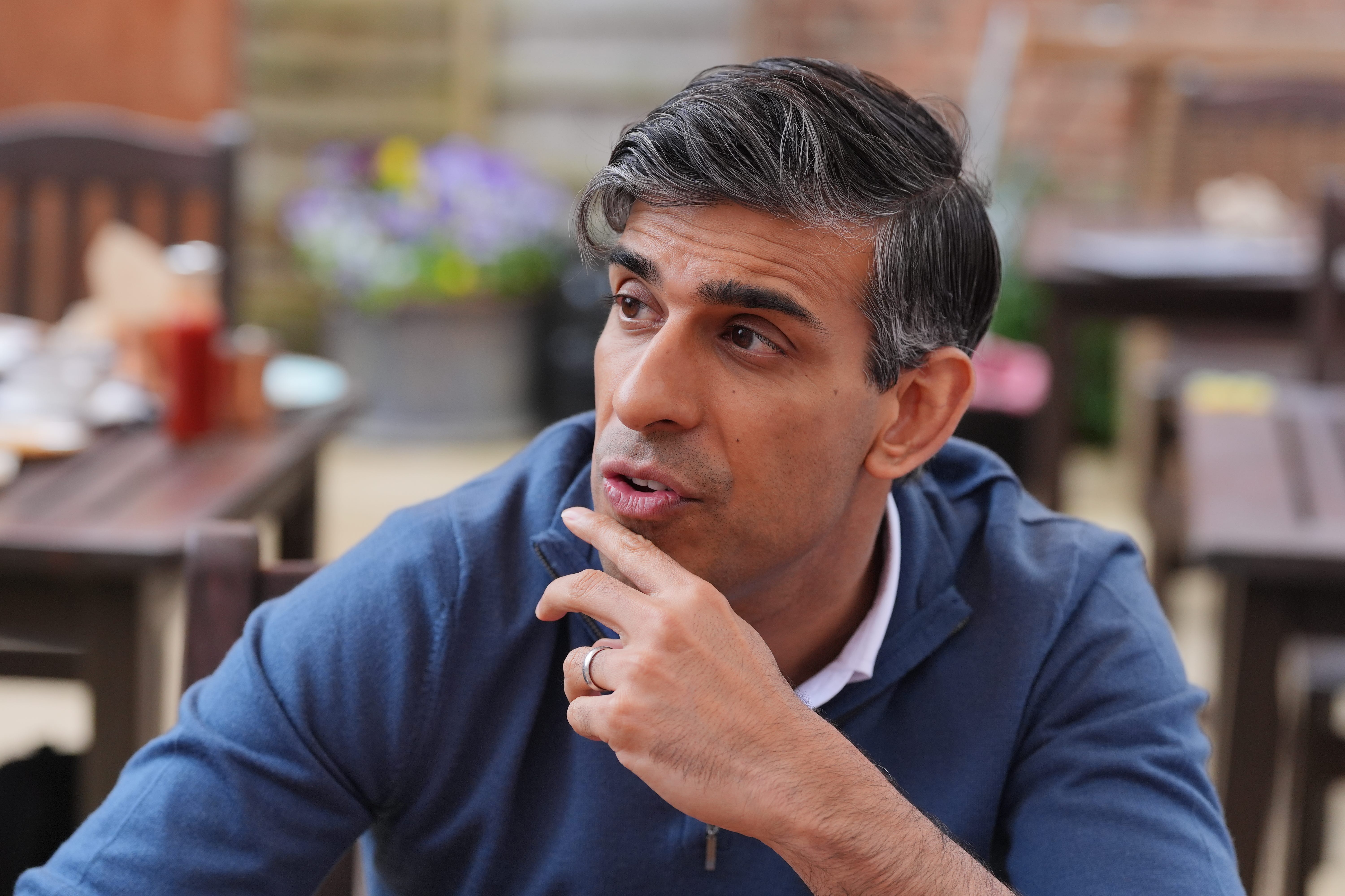 Prime Minister Rishi Sunak speaking to staff in a cafe during a visit to Wykham Park Farm in Banbury, Oxfordshire