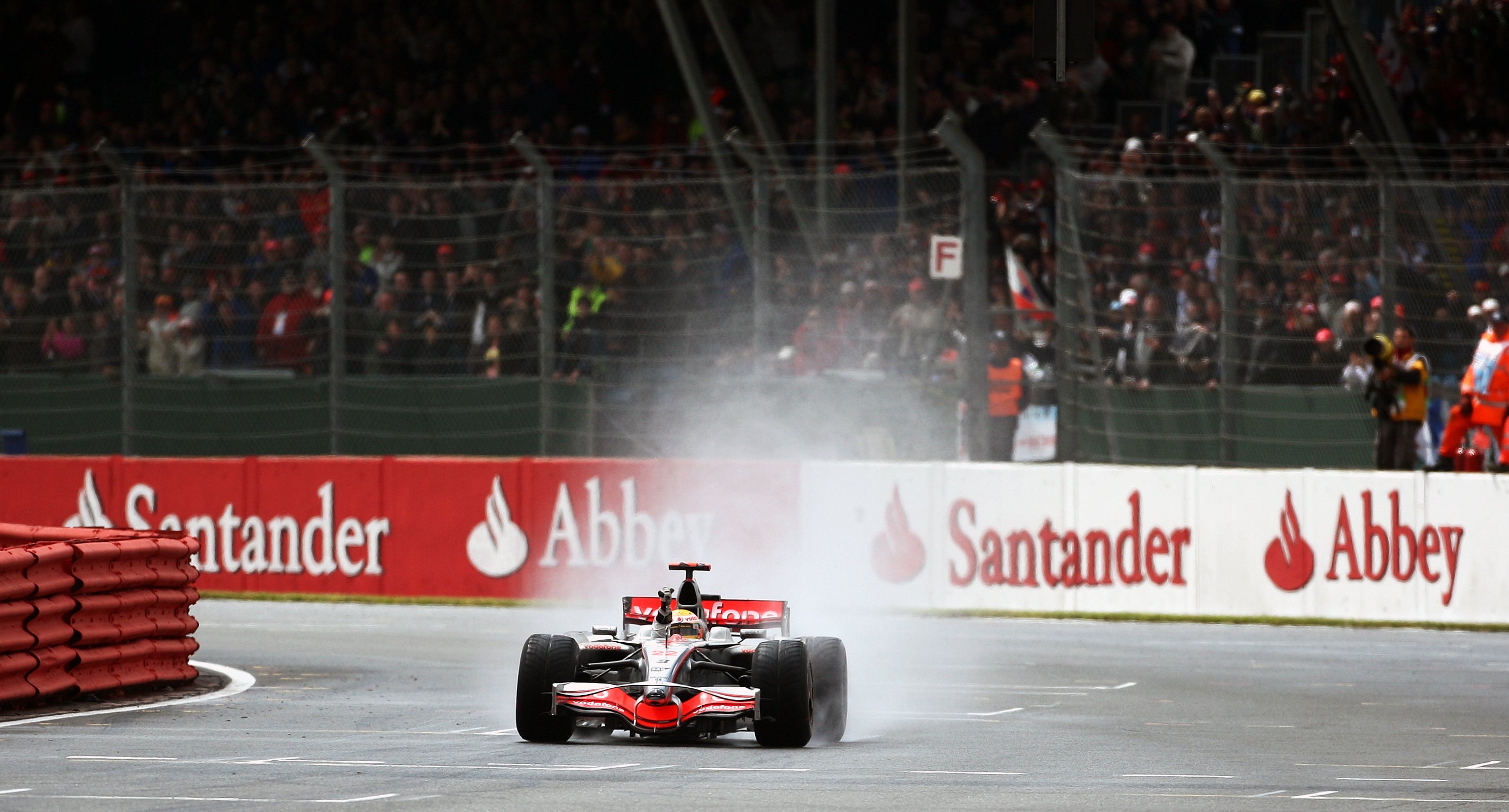 McLaren’s Lewis Hamilton on the last corner prior to taking the chequered flag to win the British Grand Prix at Silverstone (David Davies/PA)