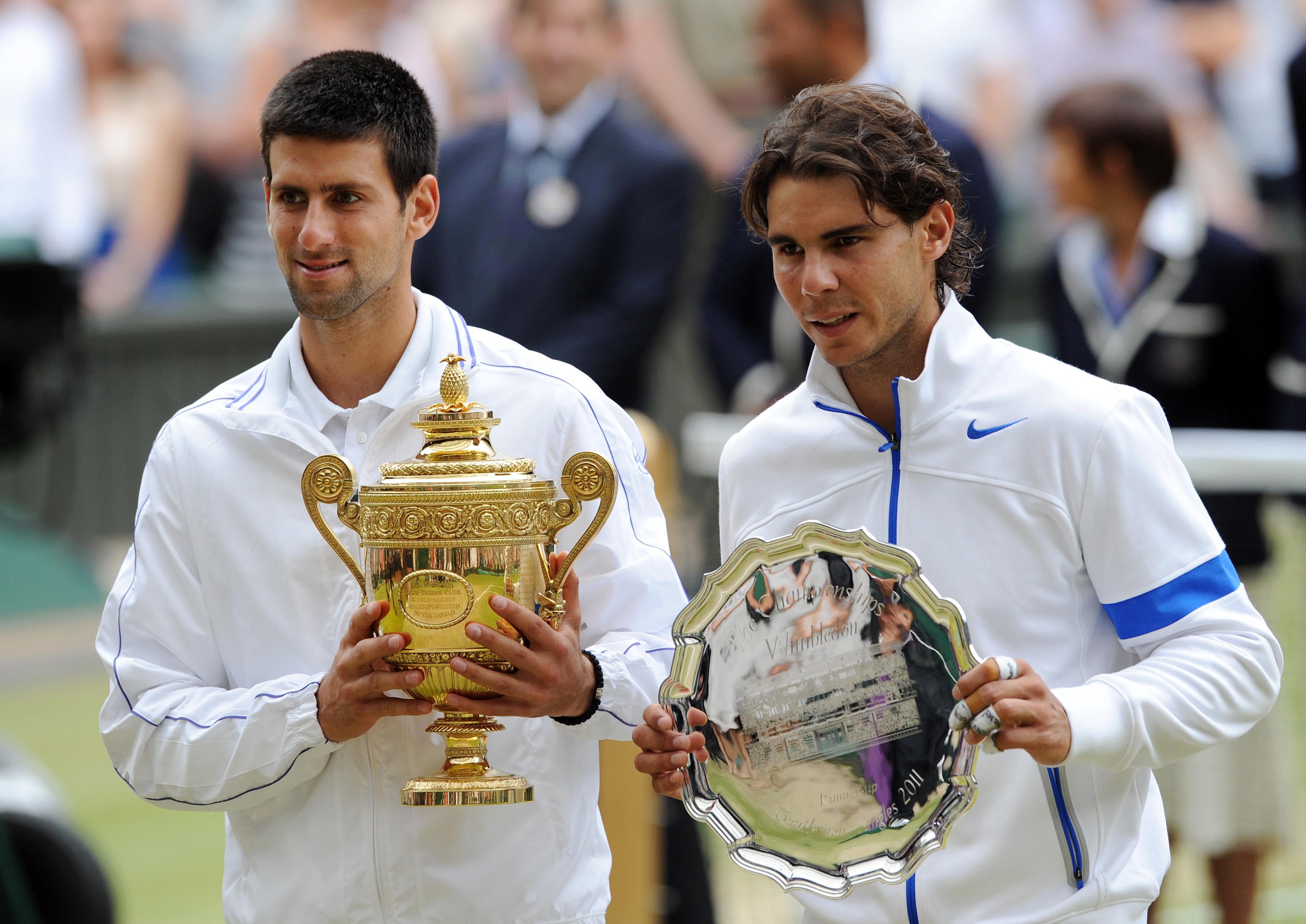 Novak Djokovic (left) and Rafael Nadal (right) pictured at the end of their 2011 men’s singles final at Wimbledon (Anthony Devlin/PA)