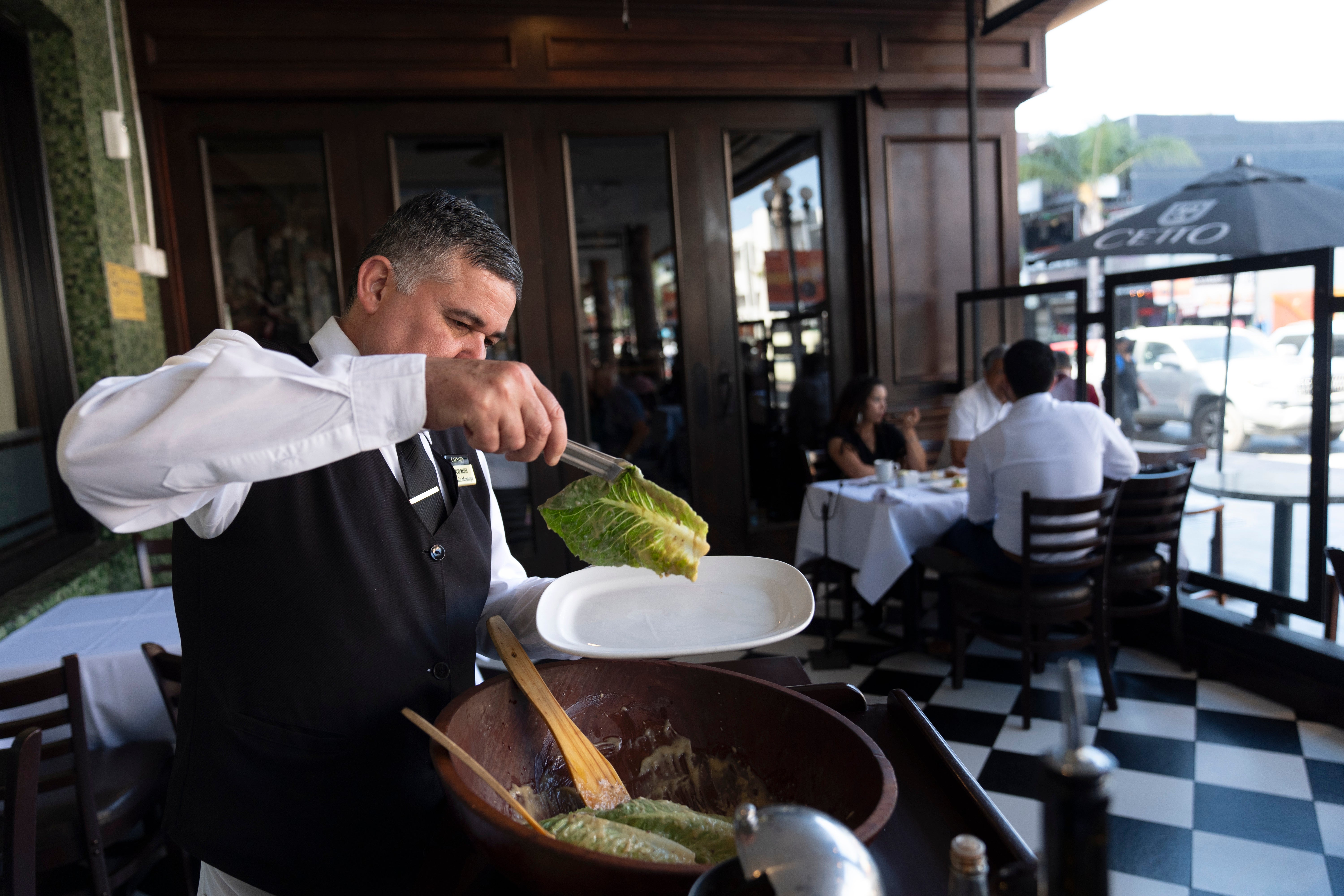 Salad Master Efrain Montoya prepares a Caesar salad at Ceasar’s restaurant Thursday, June 27, 2024, in Tijuana, Mexico