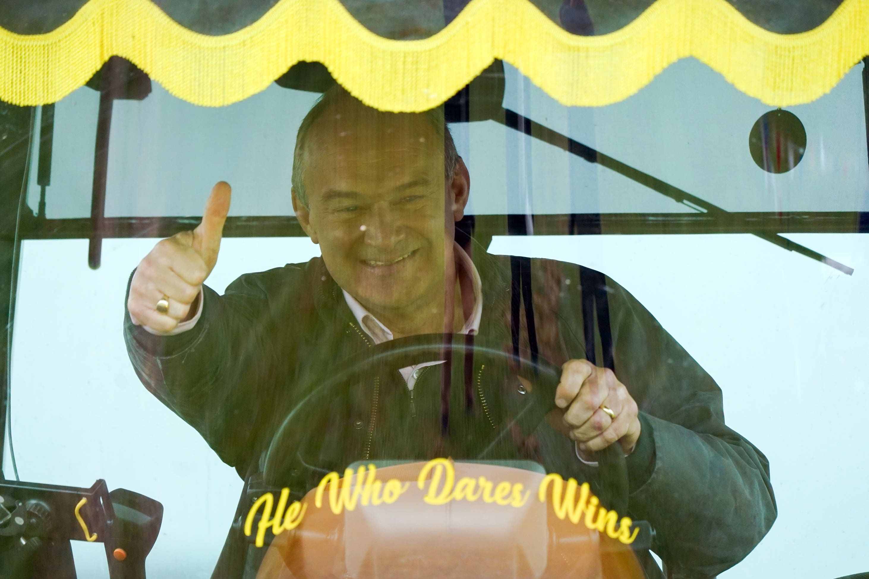 Sir Ed Davey drives a tractor during a visit to Owl Lodge in Lacock, Wiltshire (Andrew Matthews/PA)