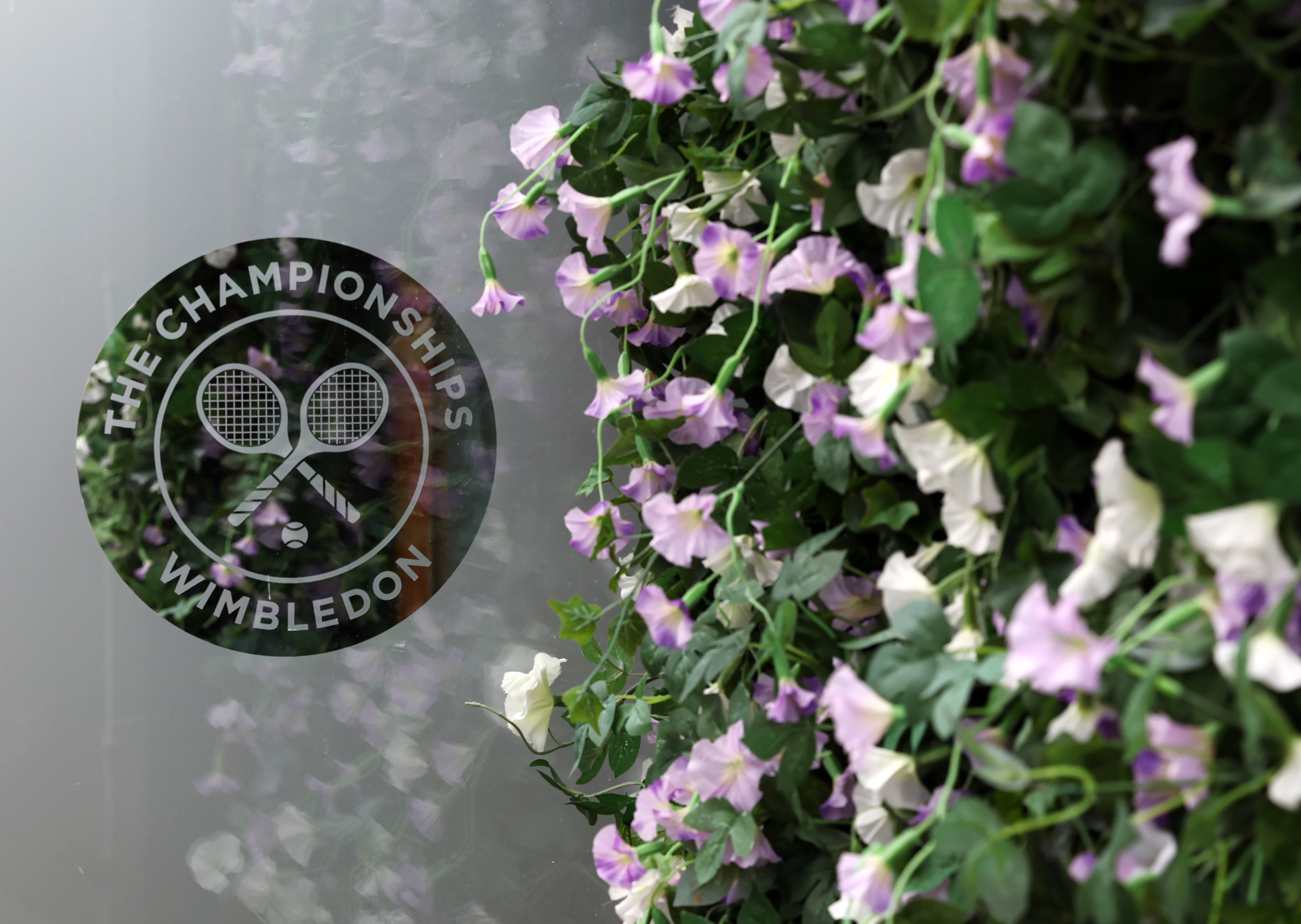 A general view of the Wimbledon logo next to a wall of flowers (Bradley Collyer/PA)