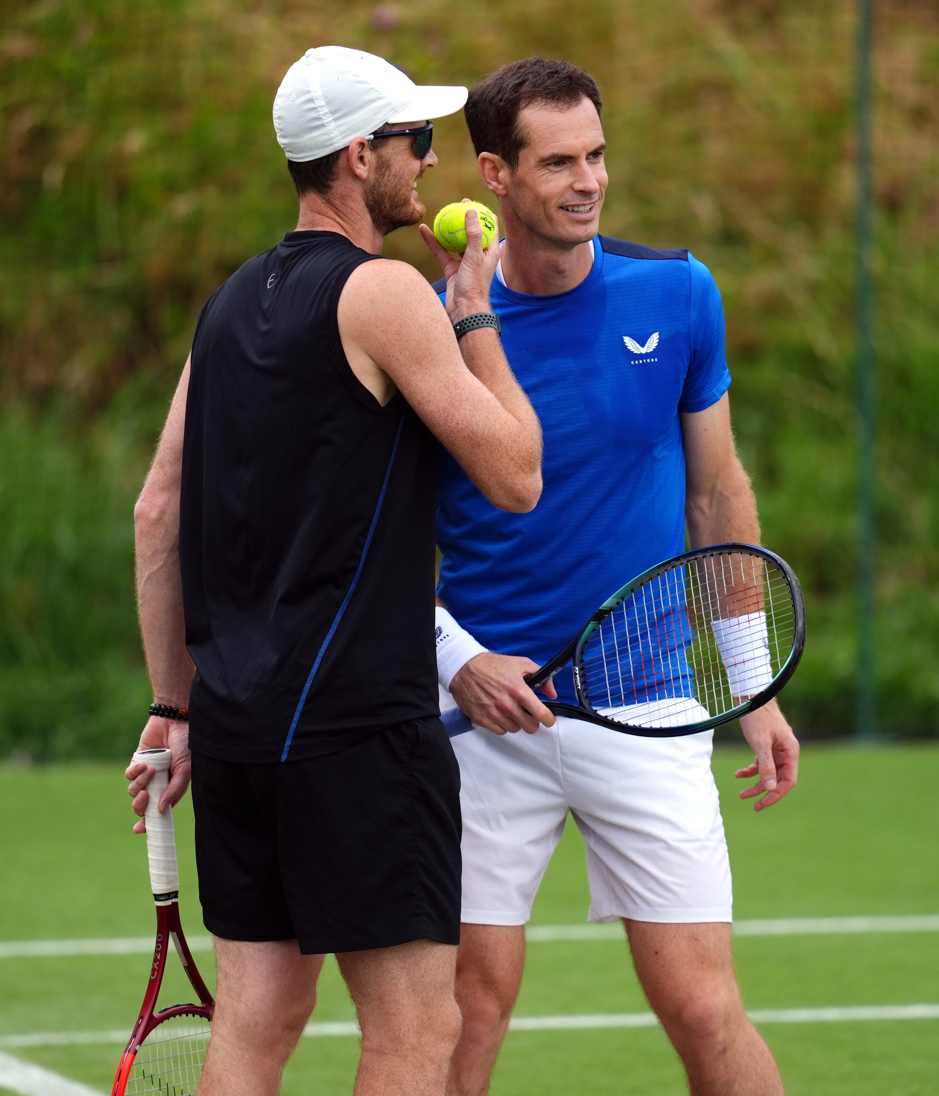 Andy, right, and Jamie Murray talk during practice (John Walton/PA)