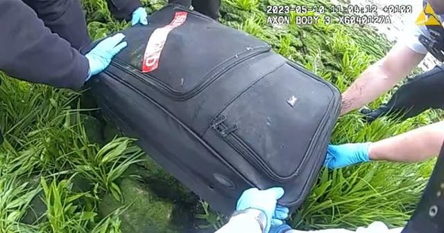 <p>Video grab of police body-worn video footage of a recovered suitcase containing the decomposed body of Suma Begum (Met Police/PA)</p>