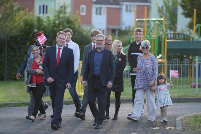 Labour Party leader Sir Keir Starmer, centre, with local parliamentary candidate Chris Bloore and other supporters arriving for a visit to Redditch in Worcestershire (Jacob King/PA)