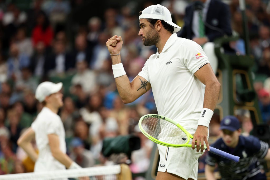 Berrettini (right) and Sinner engaged in a brutal battle on Centre Court