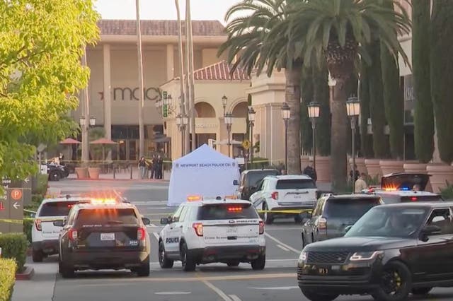 <p>Newport Beach police block access to a street where a 68-year-old woman from New Zealand was killed after she was hit by a car driven by suspects who tried to rob her at the Fashion Island mall in July 2024</p>