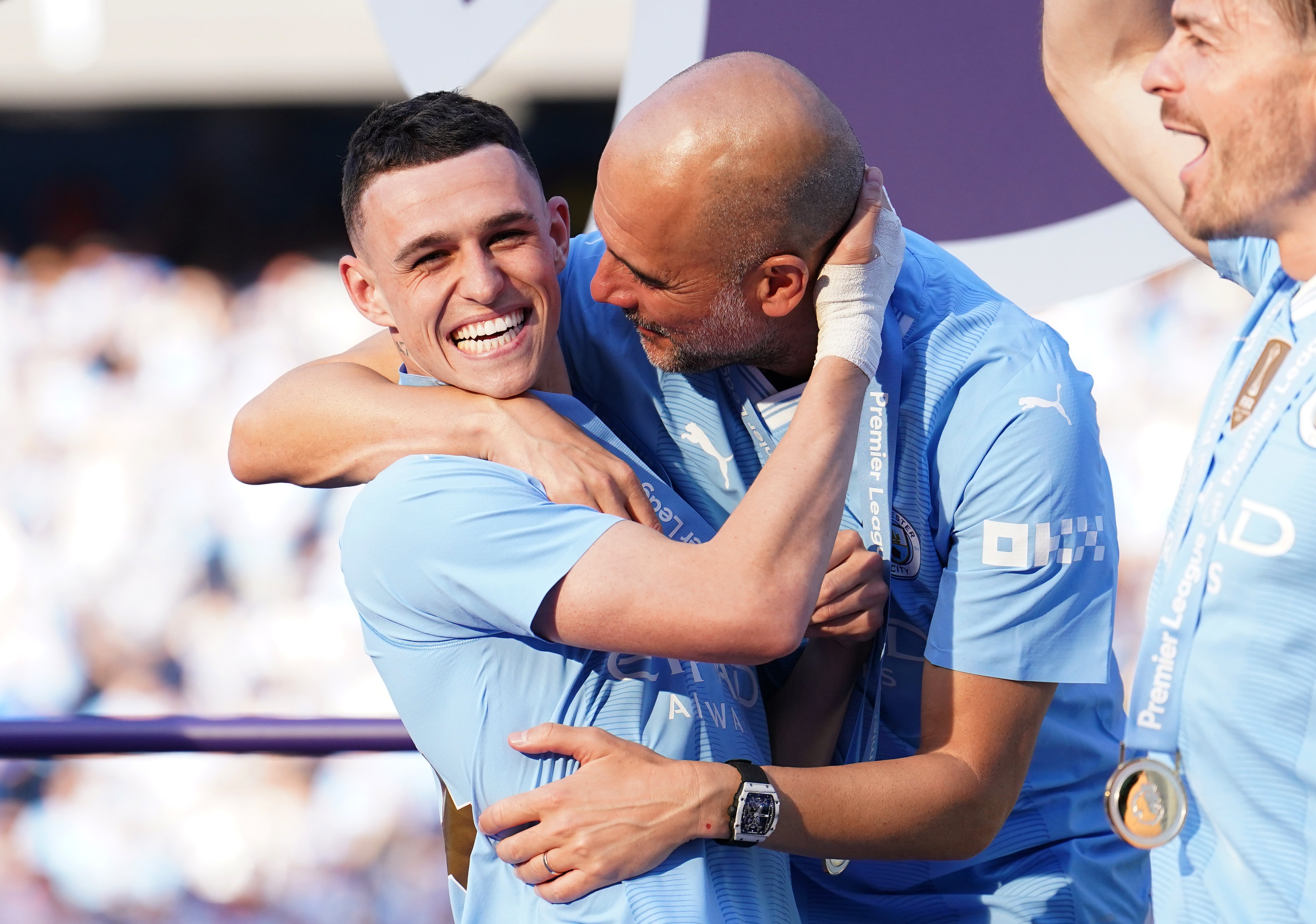 Manchester City manager Pep Guardiola celebrating with Phil Foden after winning a fourth consecutive Premier League title (Martin Rickett/PA)