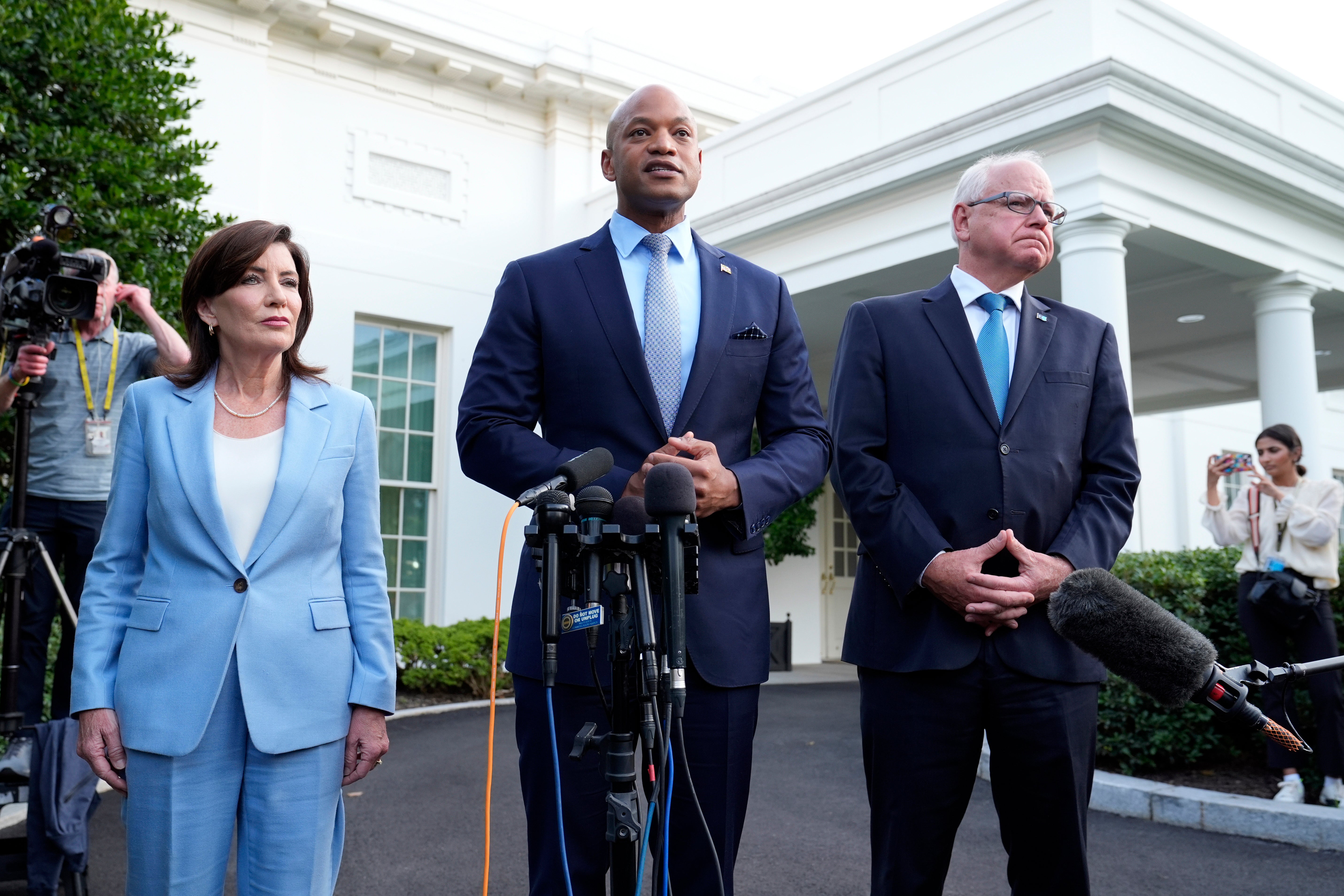 Maryland Gov. Wes Moore (center), standing with New York Gov. Kathy Hochul (left) and Minnesota Gov. Tim Walz (right), spoke with reporters after meeting with President Joe Biden. The three were some of the Democratic governors who spoke to the president and pledged their support