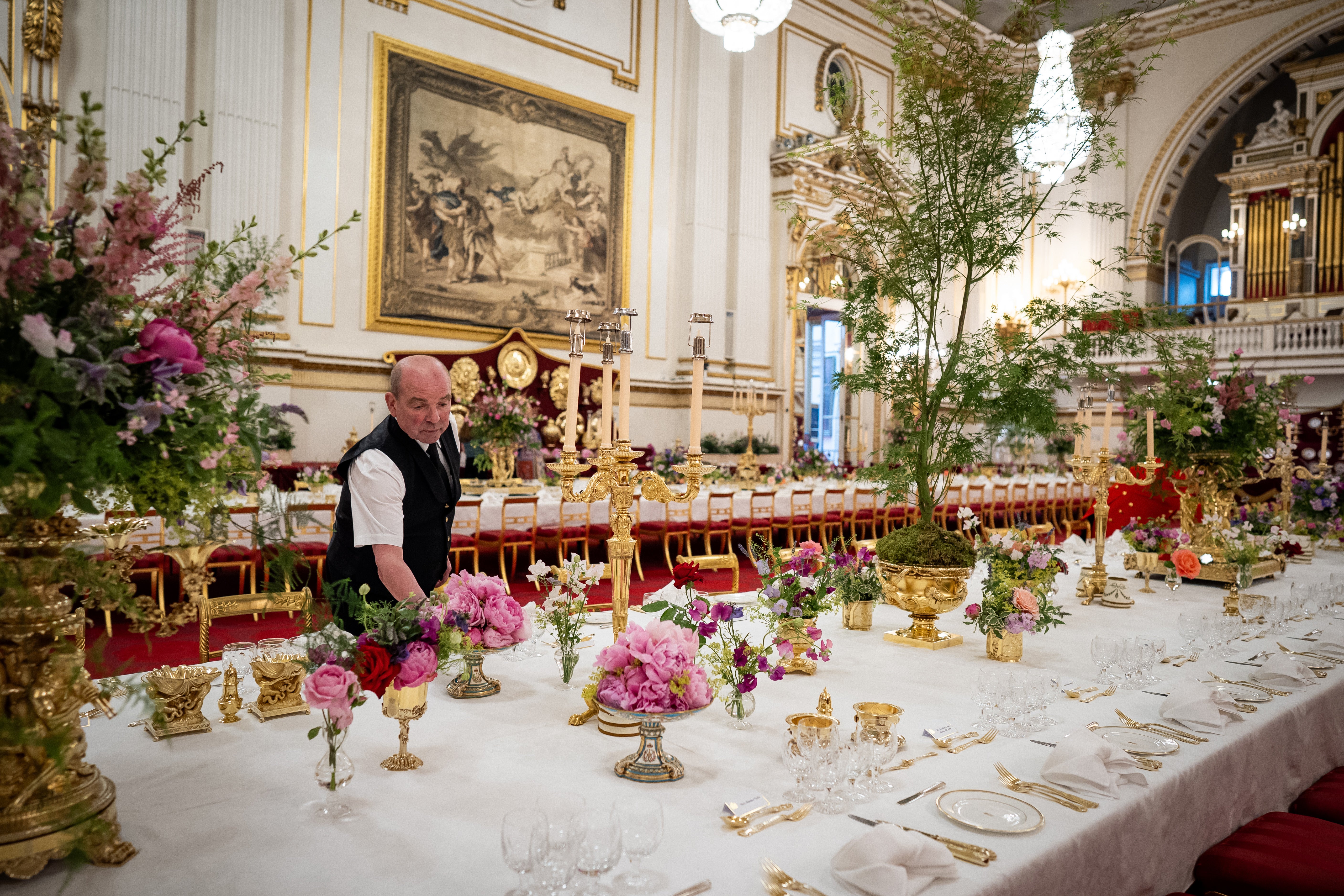 The finishing touches being applied to the tables in the Ballroom of Buckingham Palace before the state banquet (Aaron Chown/PA)