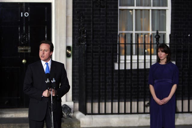 David Cameron, watched by his wife Samantha, addresses the nation from the steps of No 10 for the first time as prime minister (Chris Raeburn/PA)