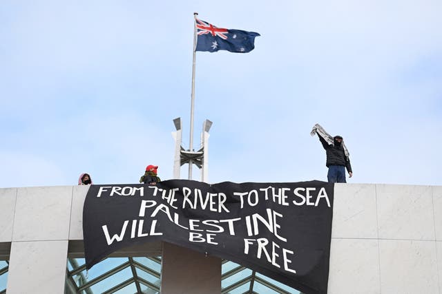 <p>Pro-Palestinian protesters hang banners from the roof of Australia’s parliament in Canberra on 4 July 2024</p>