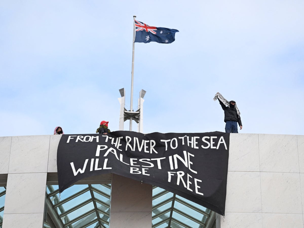 Pro-Palestinian protesters unfurl banners against Gaza war from roof of Australia’s parliament