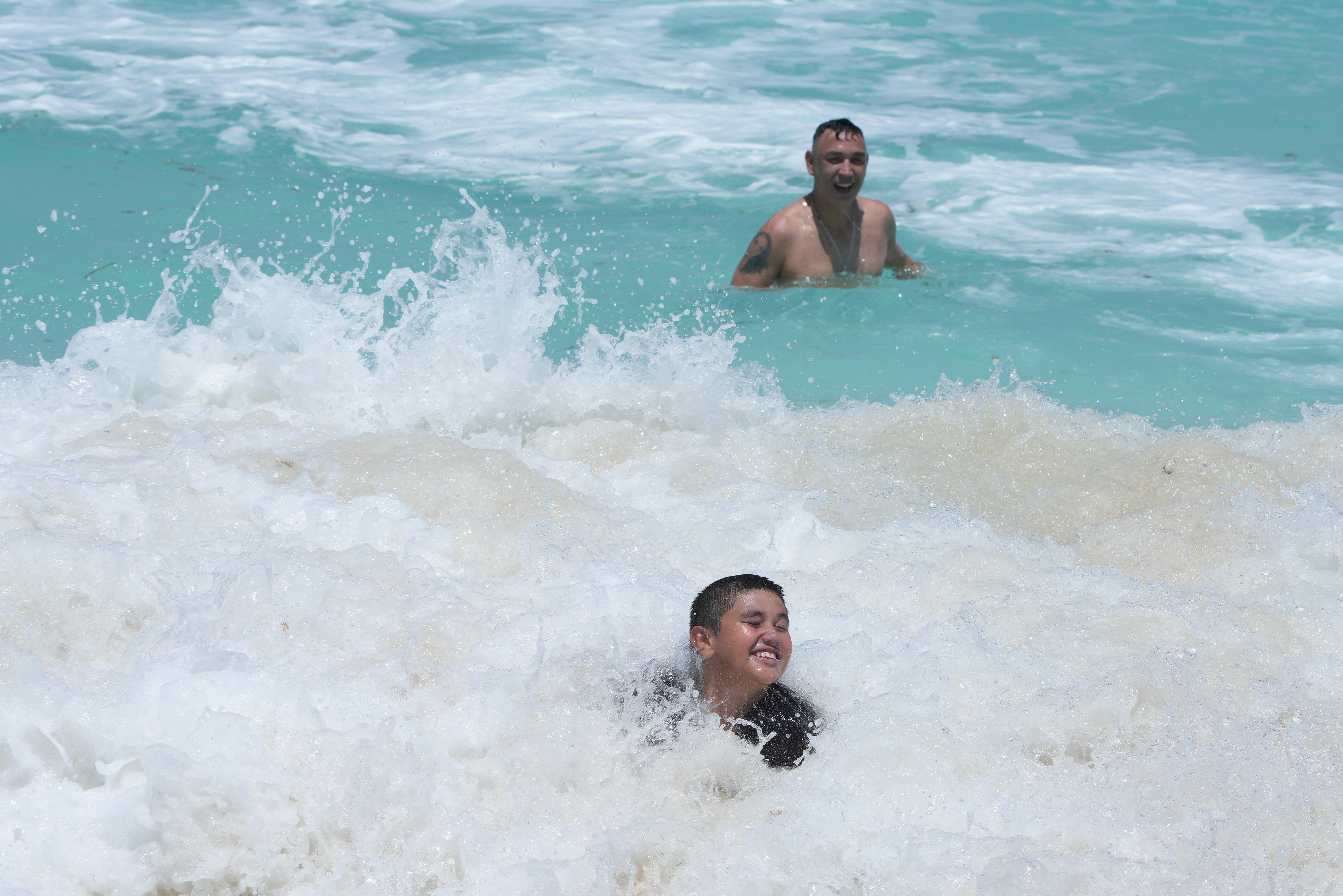 Mexico Tropical Tourists swim in the ocean ahead of Hurricane Beryl’s expected arrival in Cancun, Mexico, Wednesday, July 3
