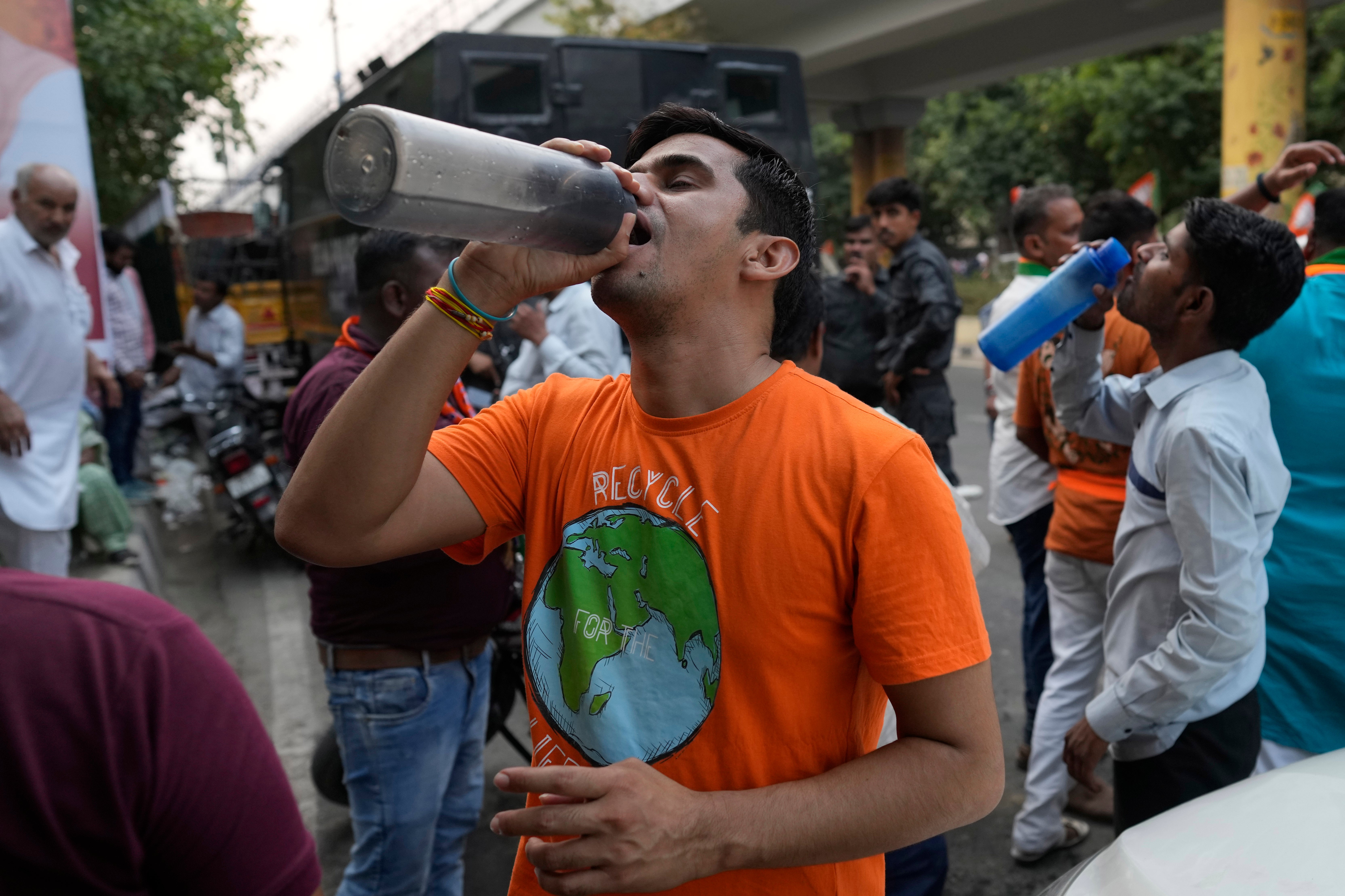File. A man drinks water at a roadside stall serving free drinking water to commuters as Delhi reels from a heat wave in May 2024