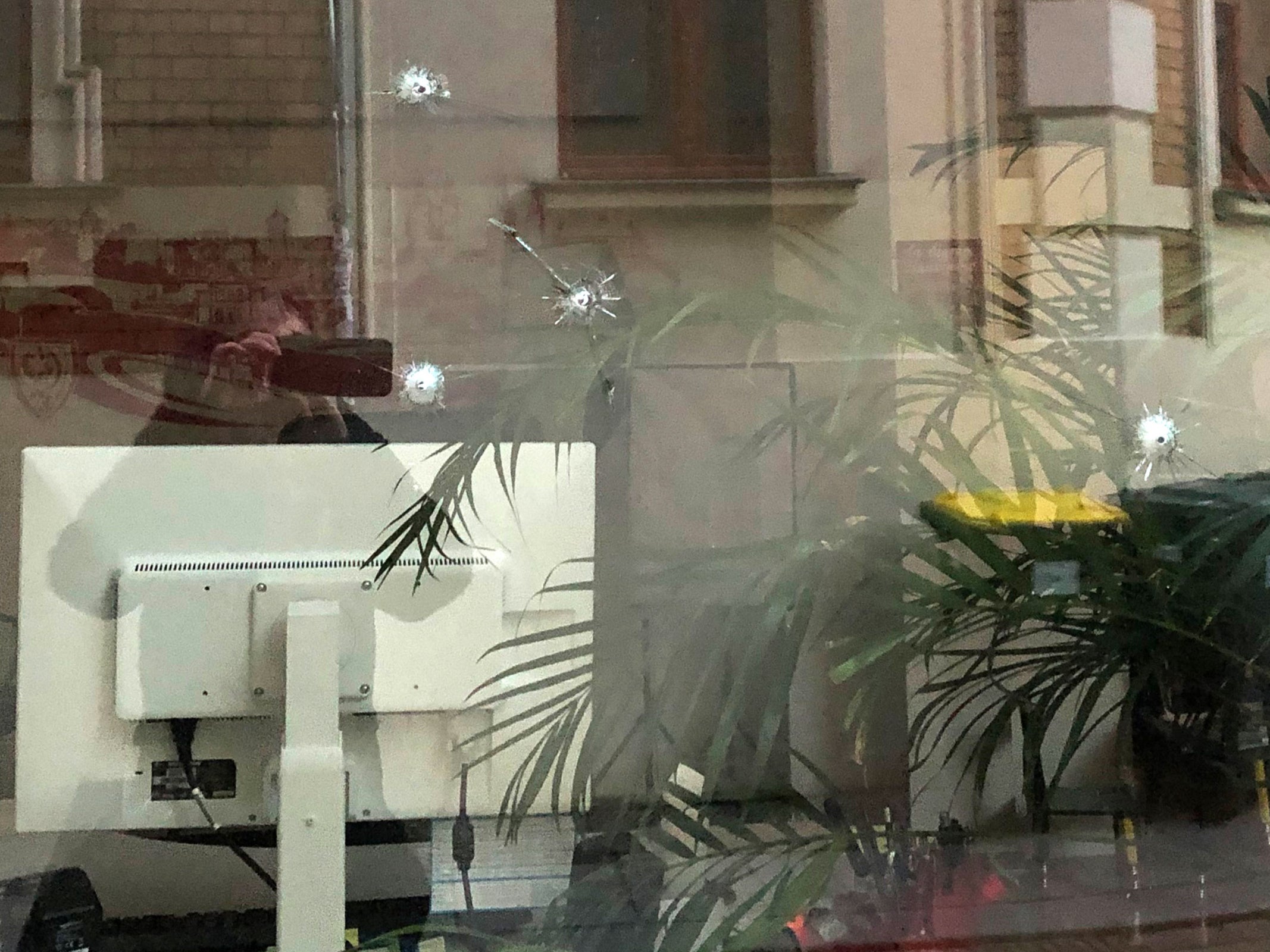 Bullet holes in the window of Karamba Diaby’s constituency office in Halle