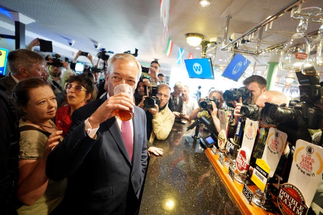 Leader of Reform UK Nigel Farage enjoys a pint of beer as he launches his General Election campaign in Clacton-on-Sea, Essex on June 4 (James Manning/PA)