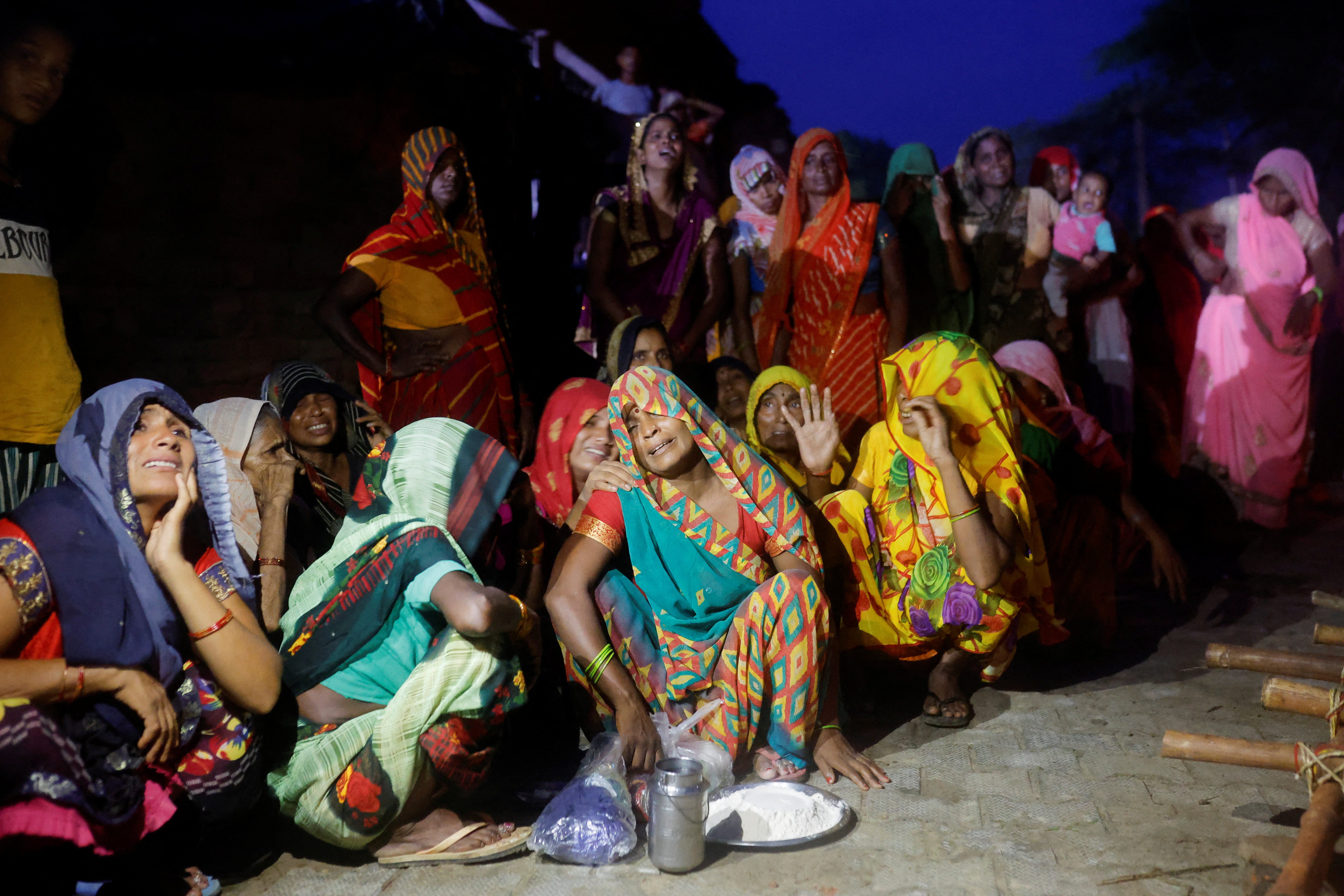Relatives mourn victims of the stampede victims at Daunkeli village in Hathras, Uttar Pradesh