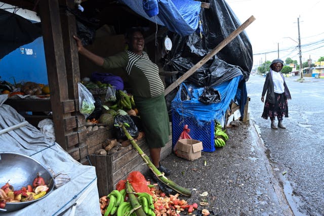 <p>A woman sells vegetables in Kingston, Jamaica, 03 July 2024. Jamaica's Prime Minister Andrew Holness stated on 03 July that Jamaican authorities have launched a special operation 'to maintain public order' during the passage of Hurricane Beryl through the Caribbean country</p>
