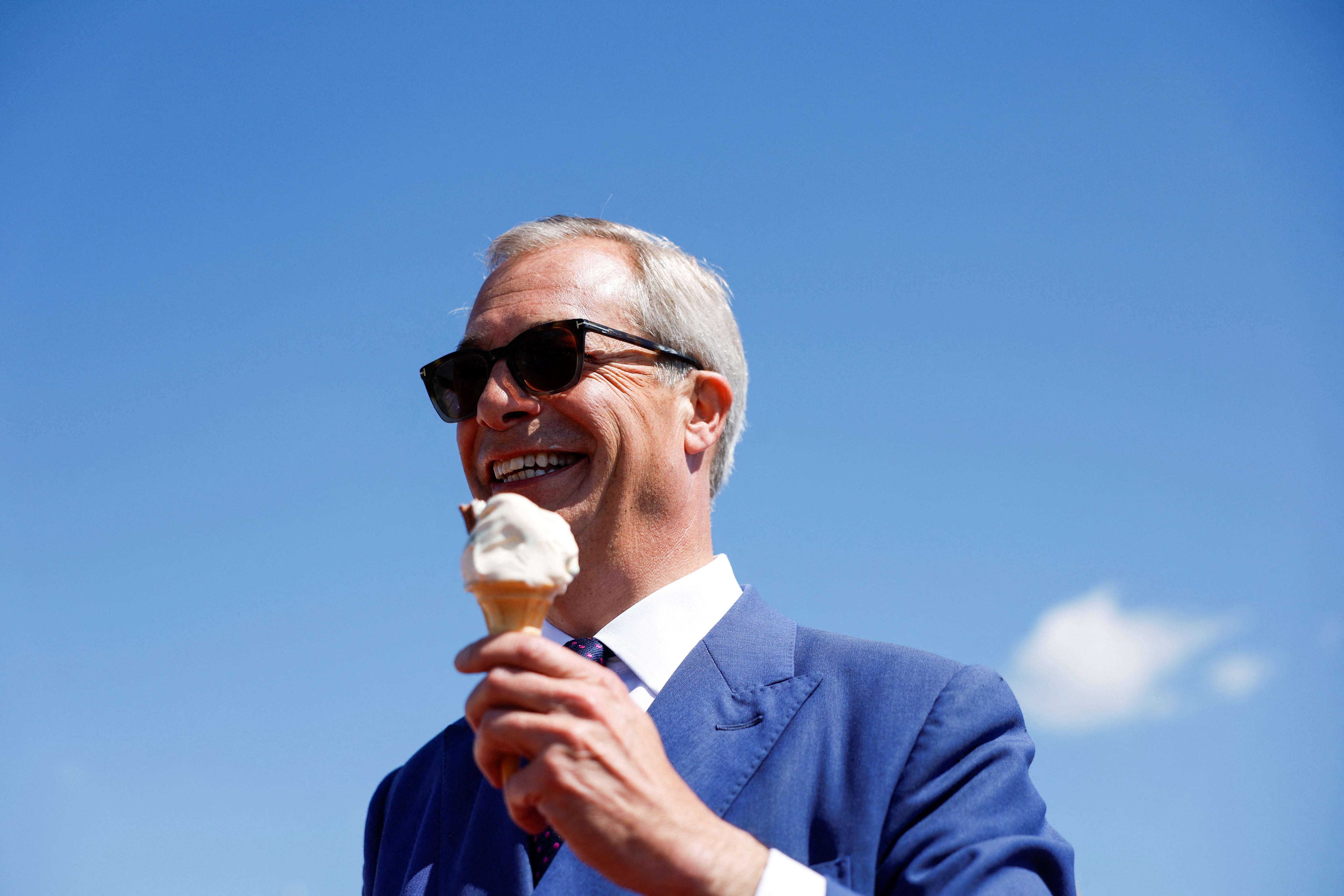 Reform UK Party Leader Nigel Farage eats an ice cream, on the day of the general election, in Clacton-on-Sea
