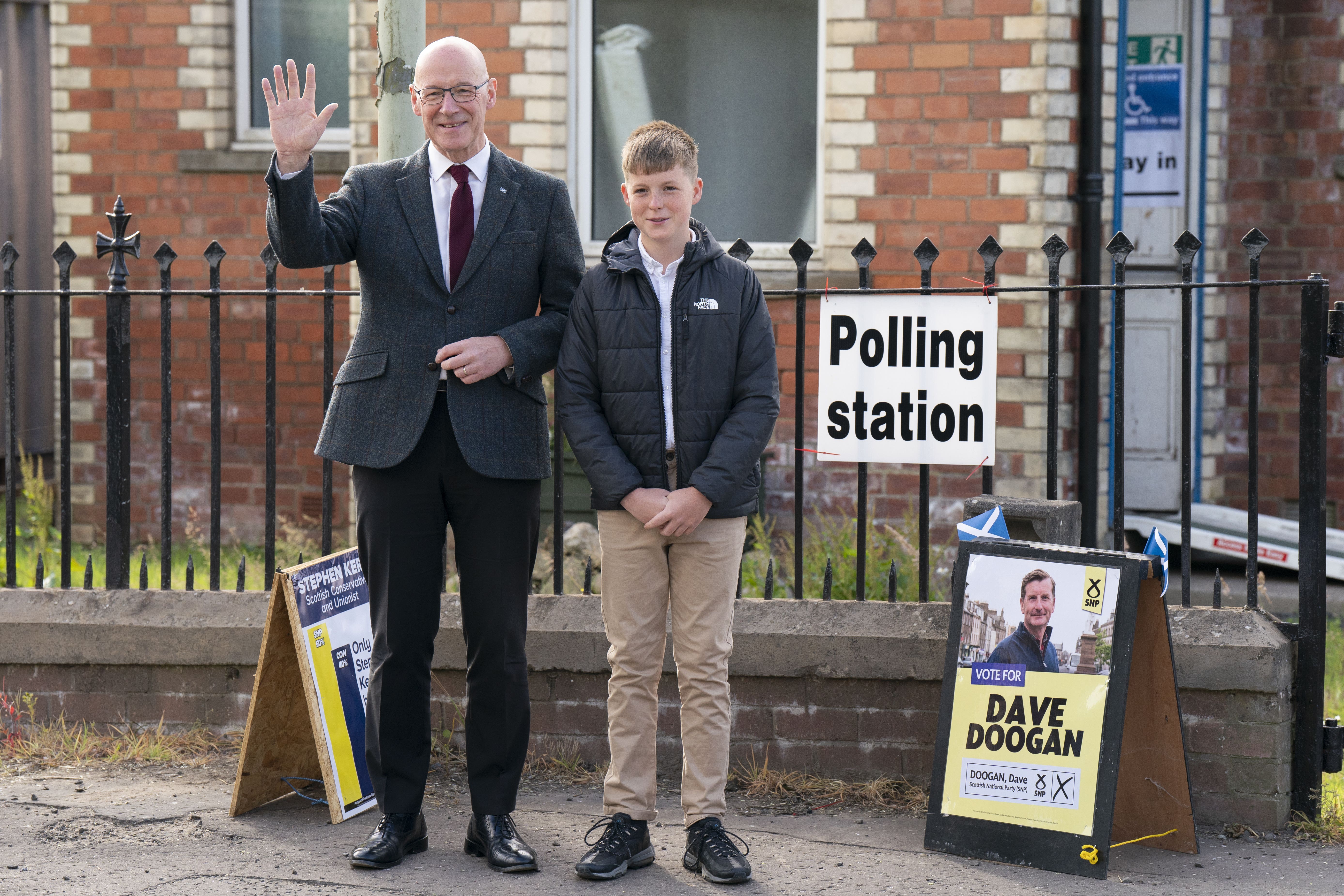 Scottish First Minister and SNP leader John Swinney, with his son Matthew, voted in Perthshire (Jane Barlow/PA)