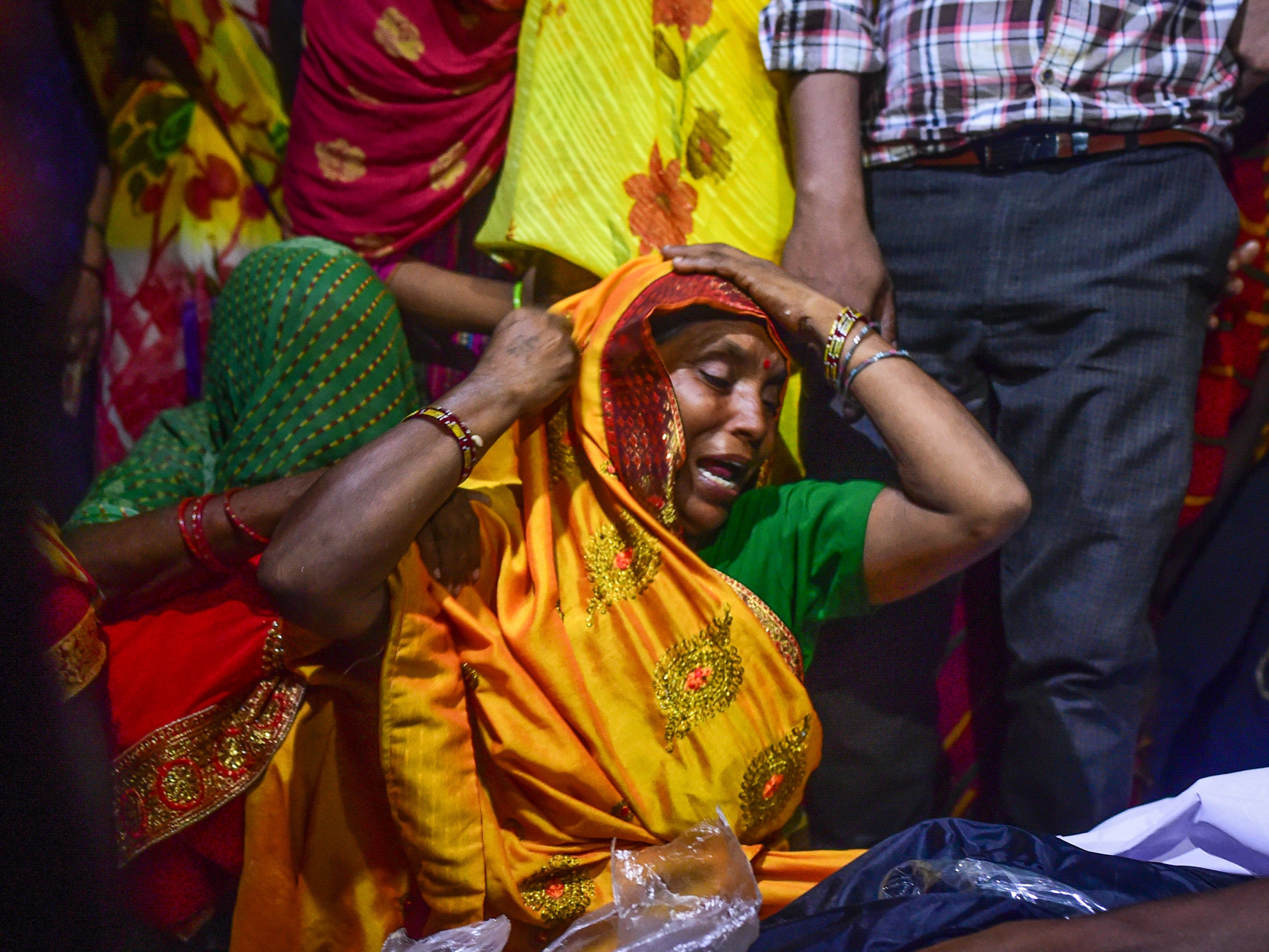Relatives mourn victims of the Hathras stampede during a cremation ceremony at Daukeli village in Hathras, India