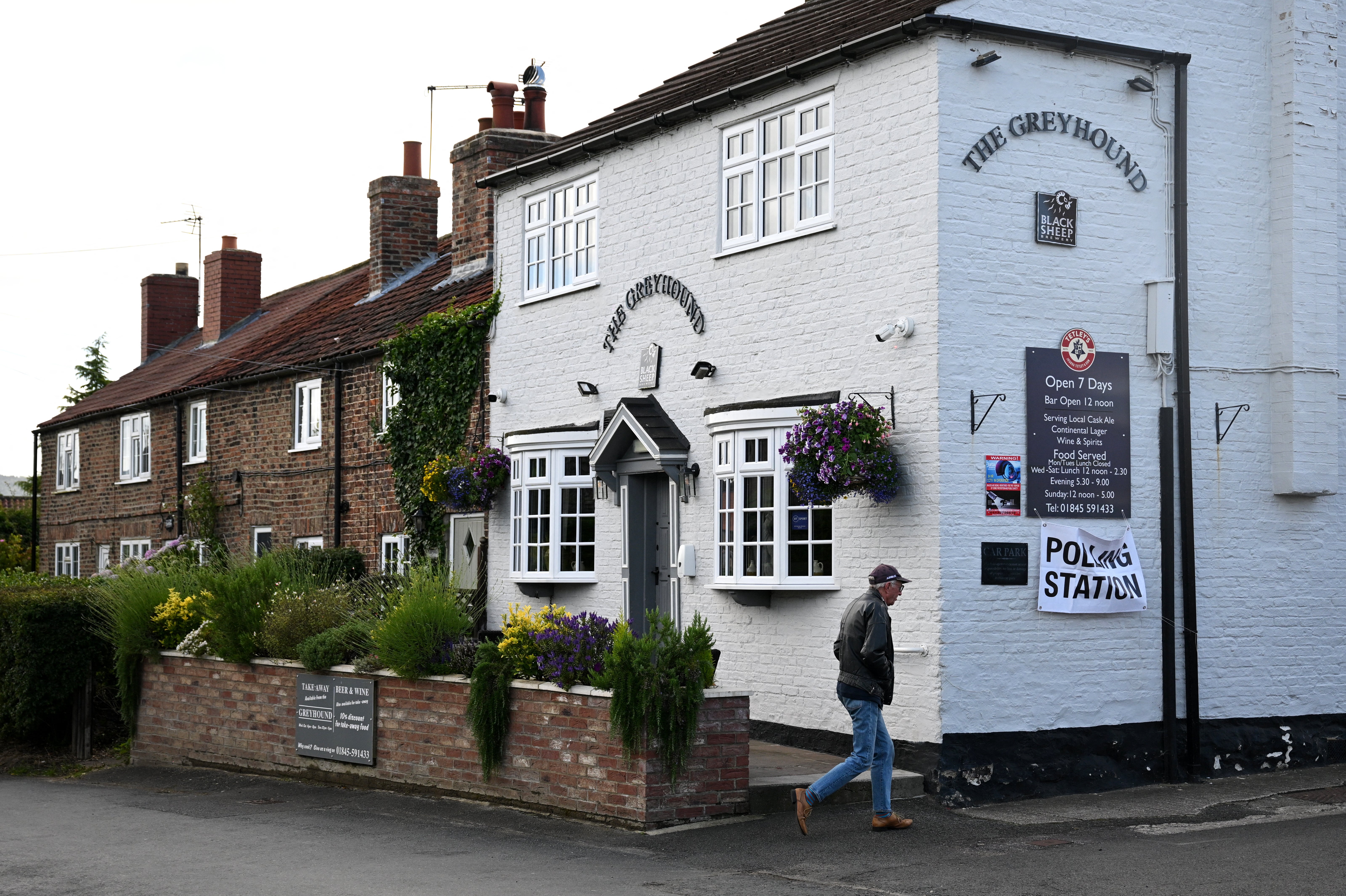 A voter makes his way to a polling station inside a pub in Bagby, north of England