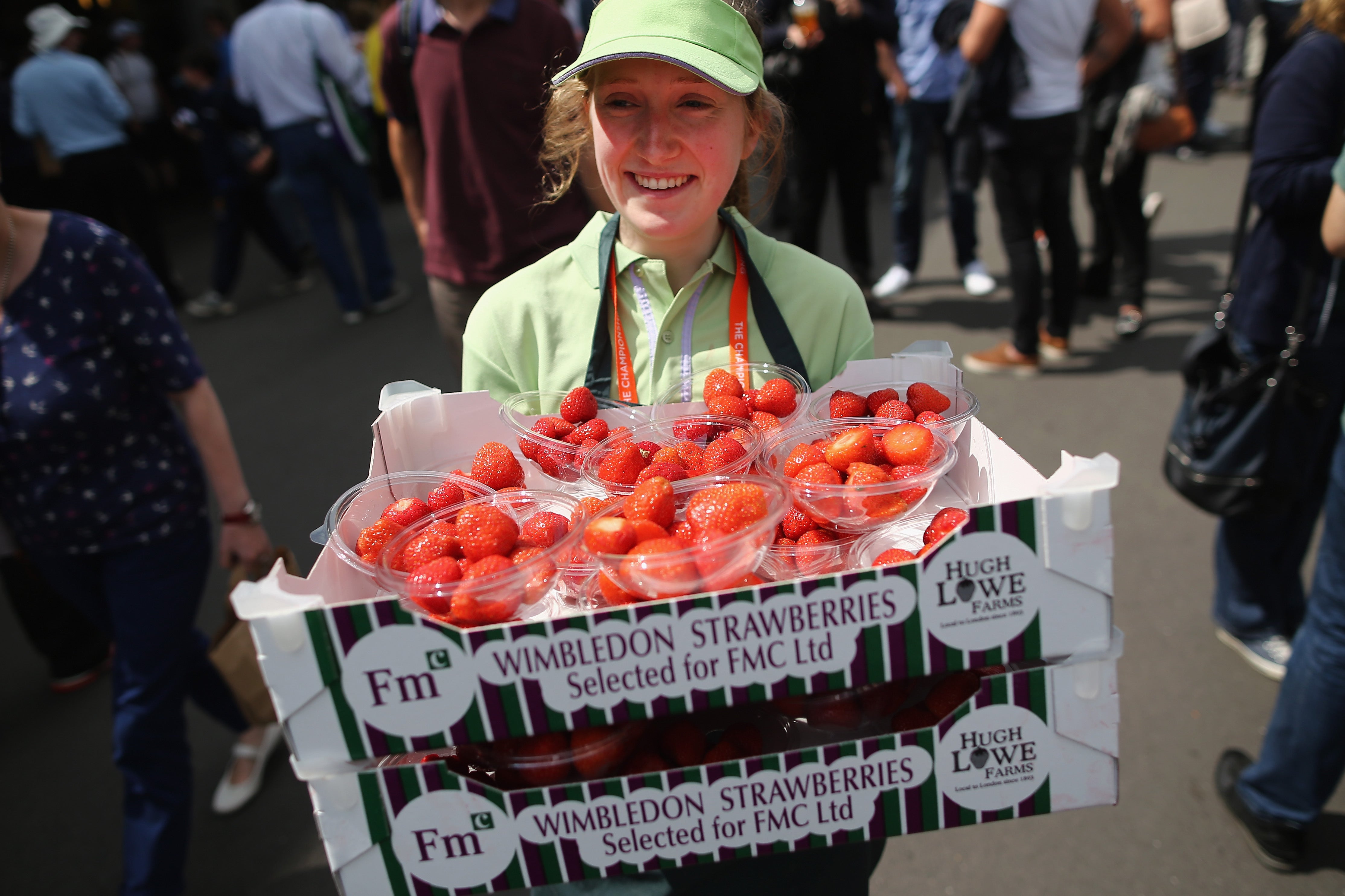 Strawberries are carried around the grounds during day two of the Wimbledon Lawn Tennis Championships