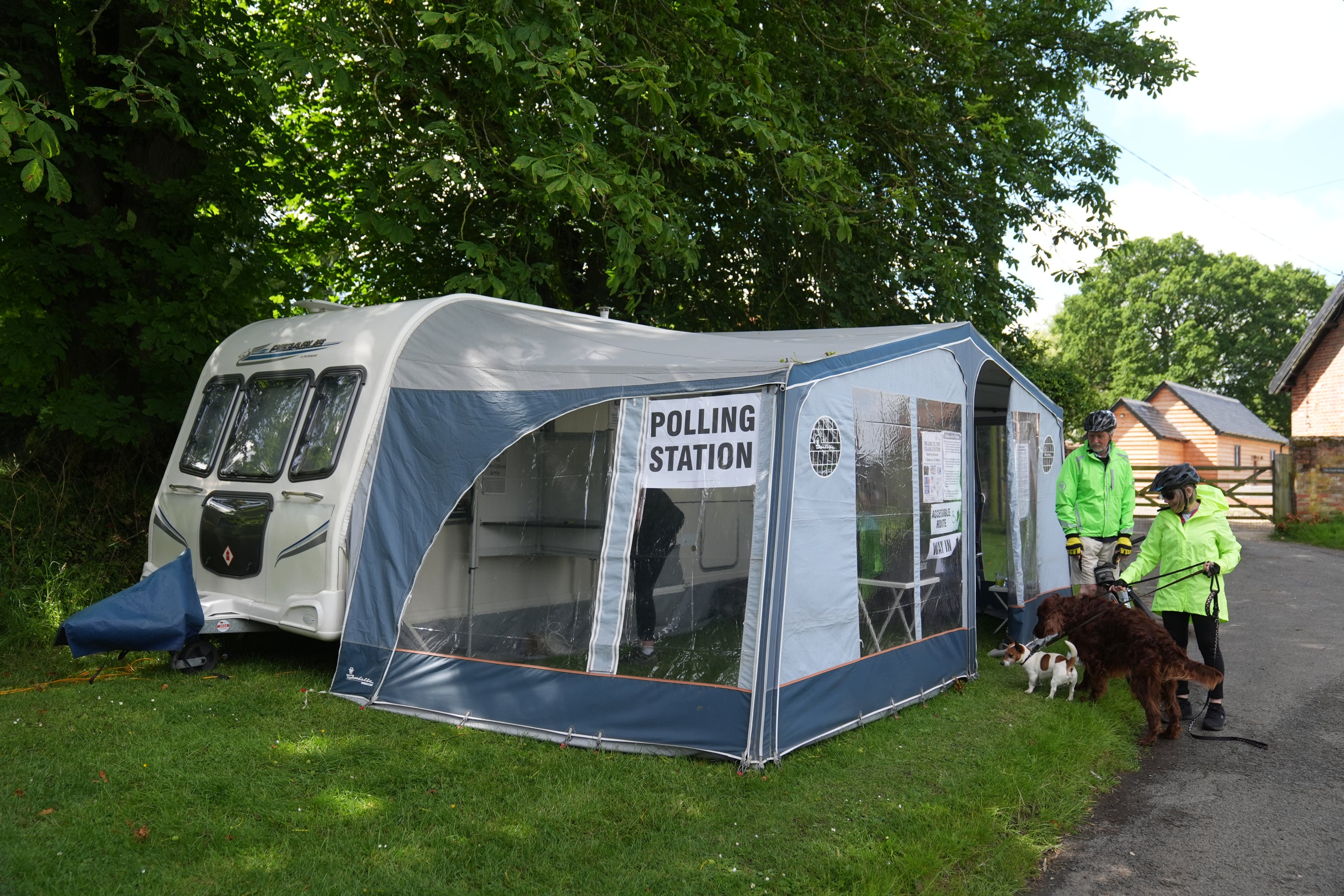 Voters arrive to cast their votes in a caravan used as a polling station in Carlton, Cambridgeshire, in the 2024 General Election