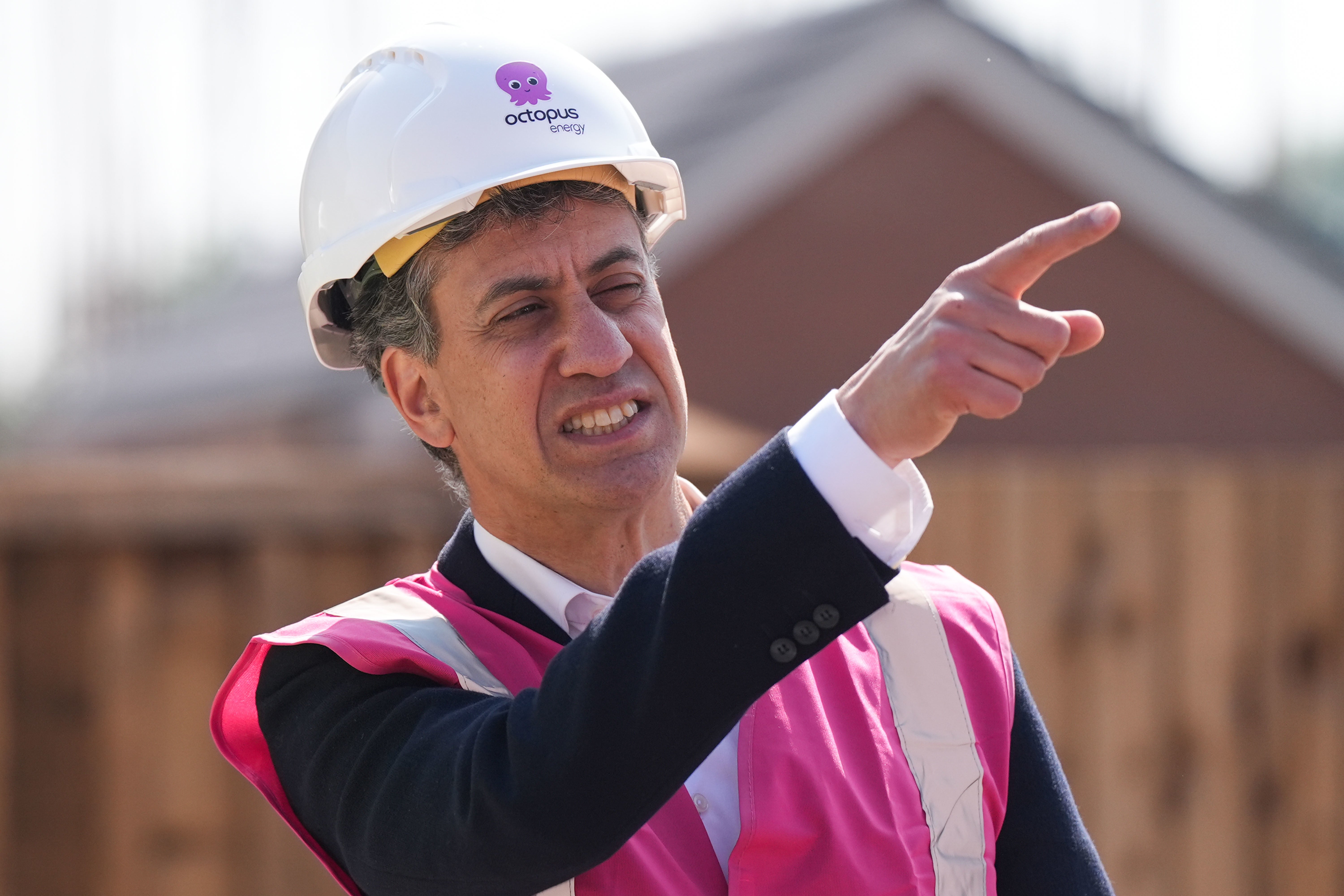 Shadow secretary of state for energy security and net zero Ed Miliband was pretty in pink (hi-vis) during a visit to a ‘Zero Bills’ home in Stafford (Jacob King/PA)