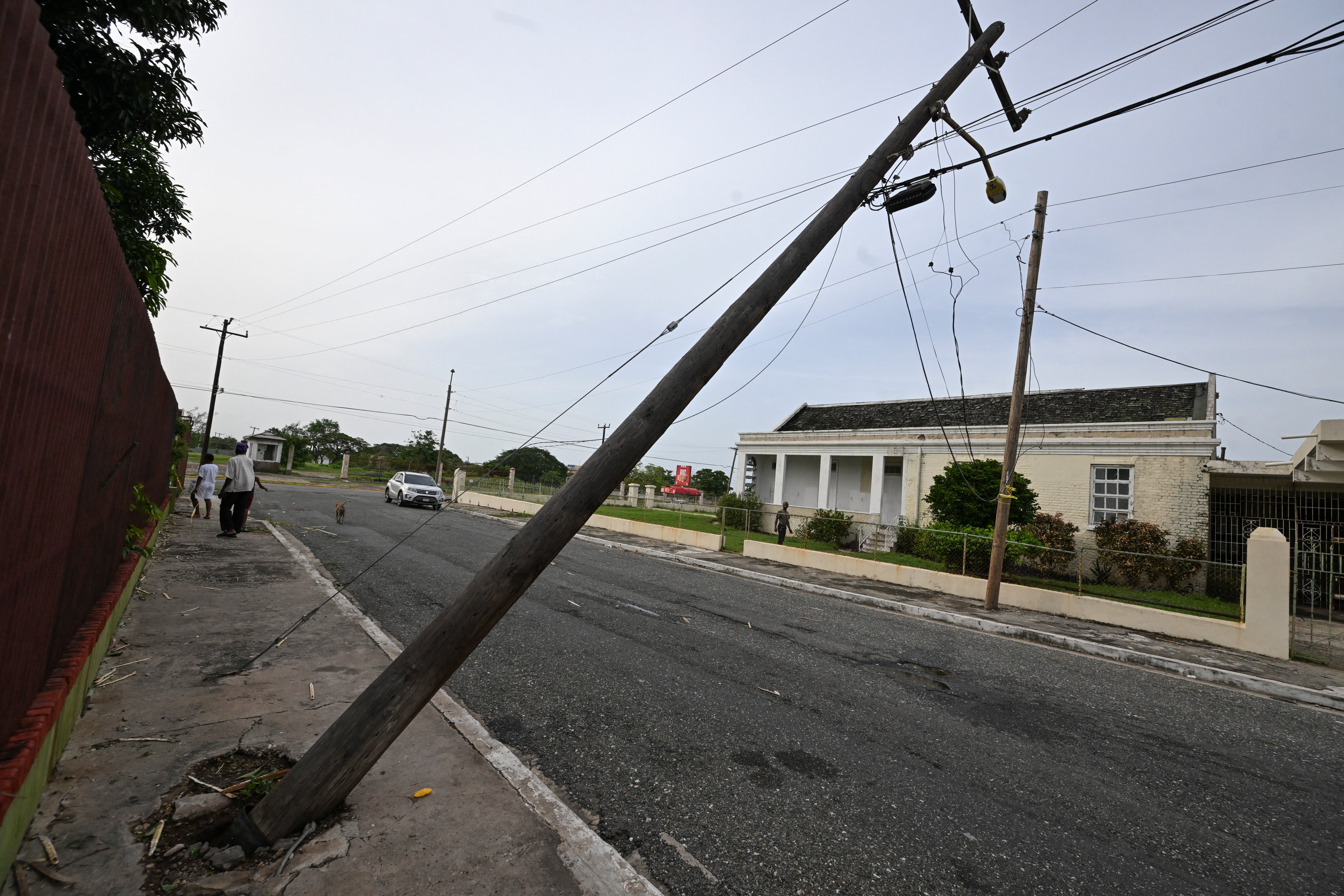 An uprooted light pole pictured in Kingston, Jamaica on Thursday after Hurricane Beryl