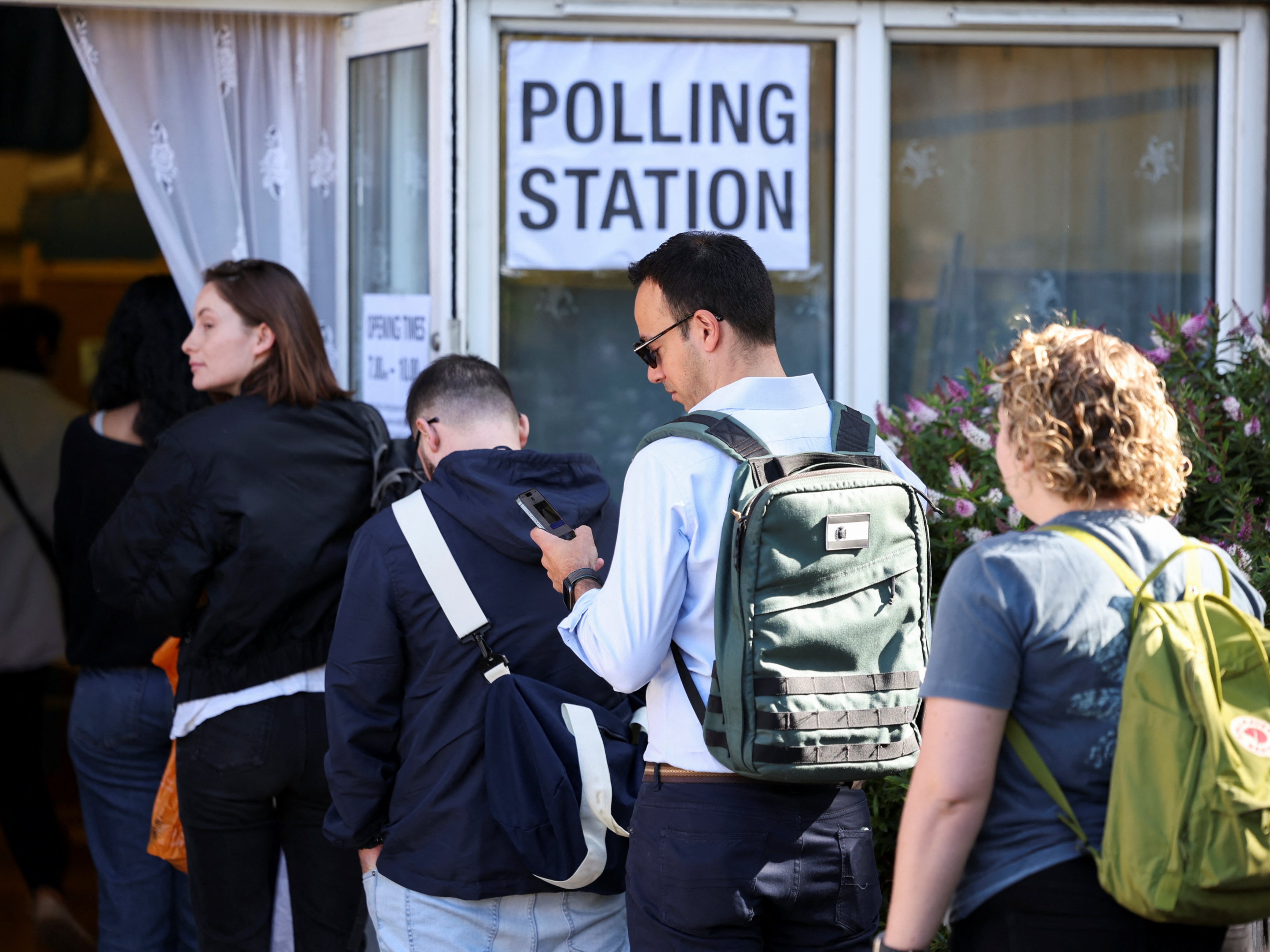 People queuing at vote at a polling station in London