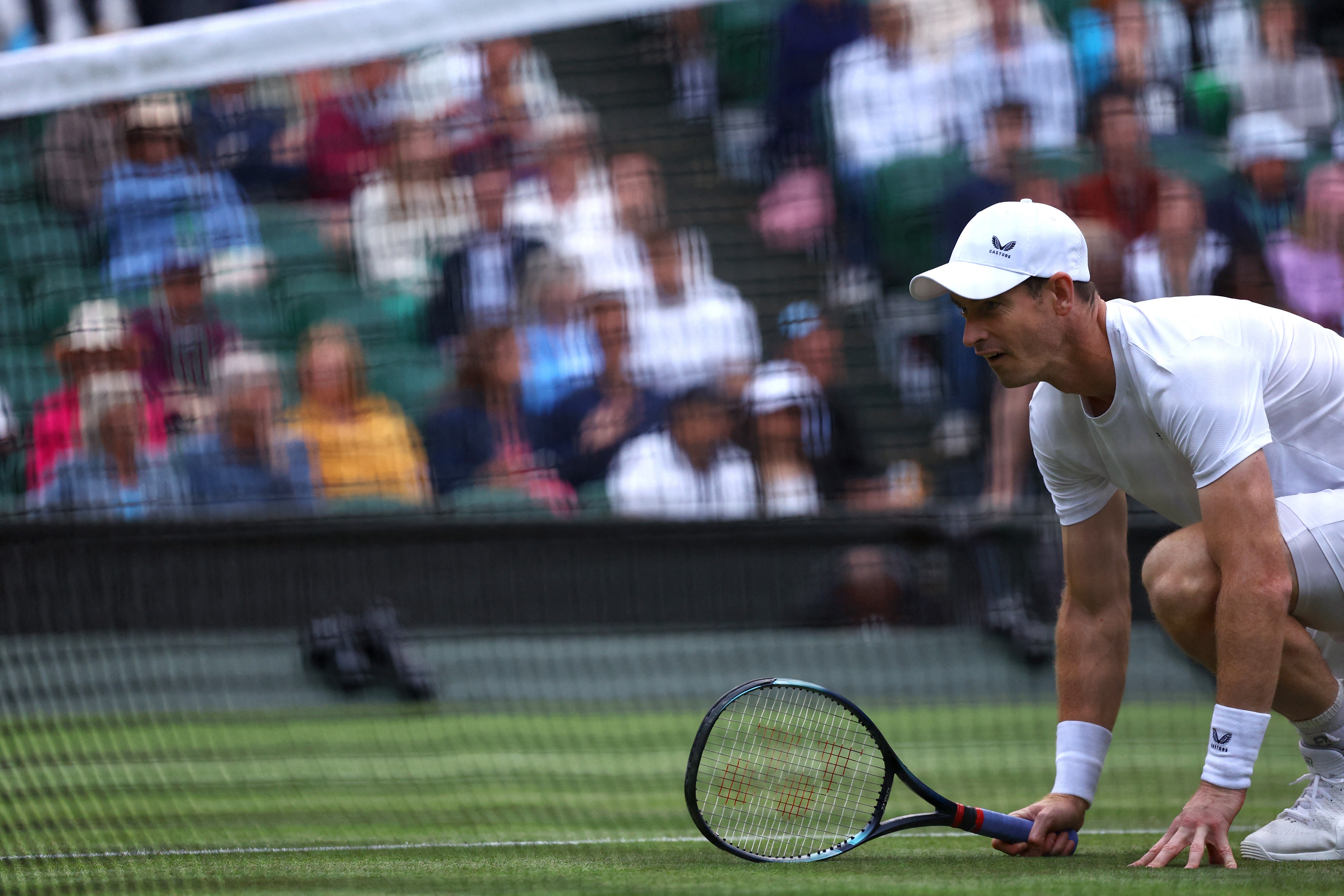 Andy Murray crouches at the net