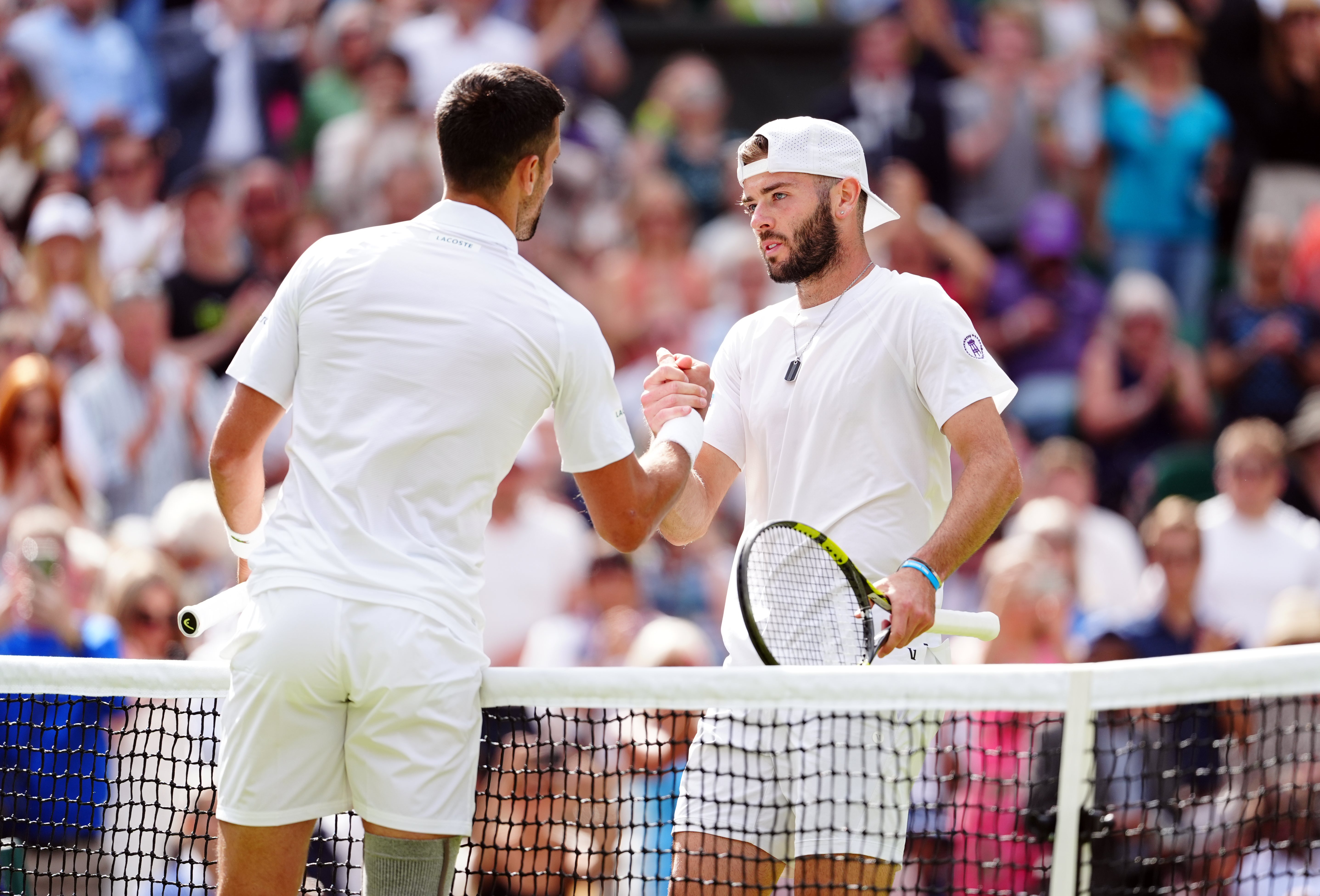 Jacob Fearnley (right) fell short of a seismic shock against Novak Djokovic