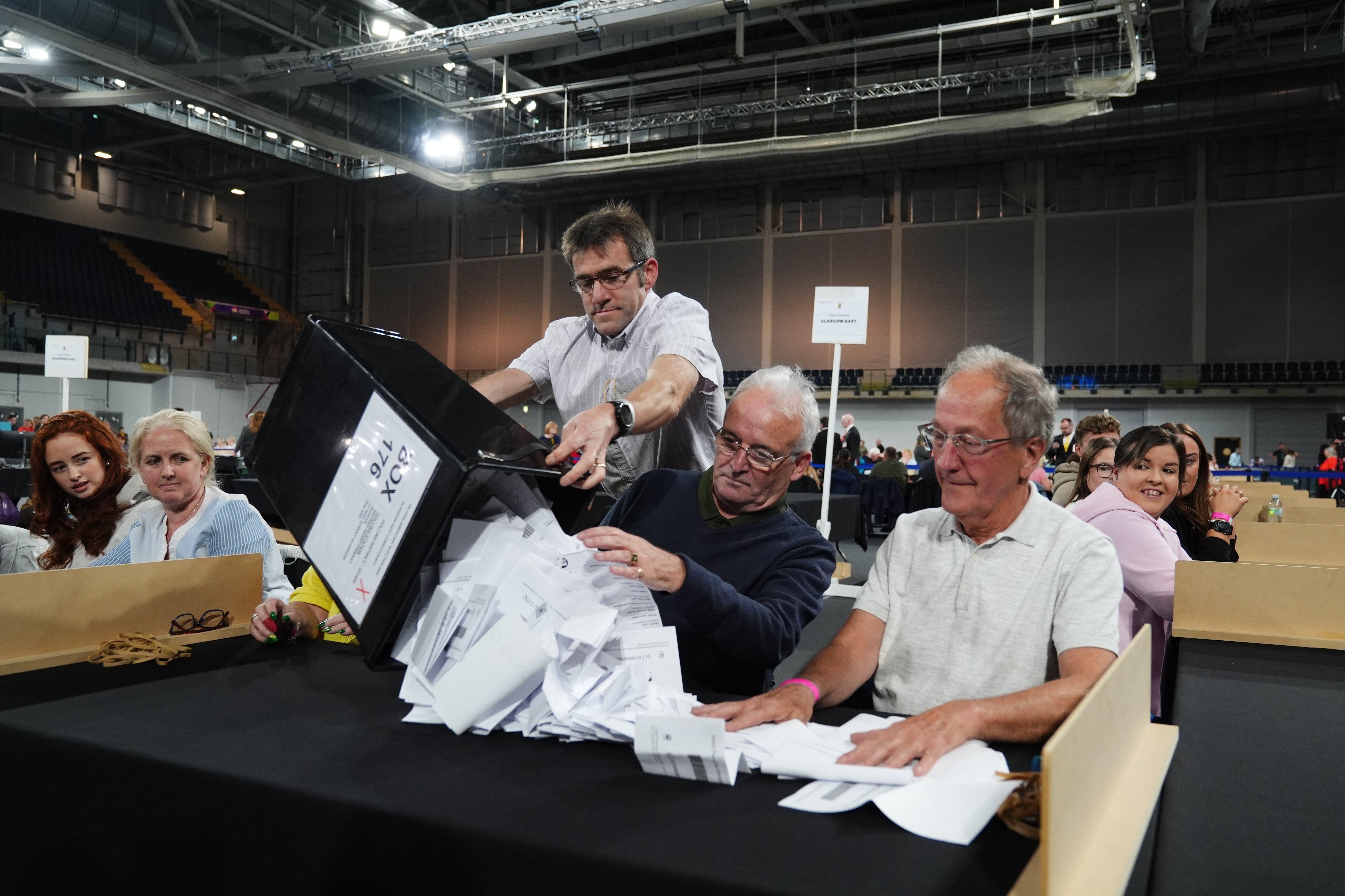 Ballot boxes are emptied at Emirates Arena in Glasgow, during the General Election count (Andrew Milligan/PA)