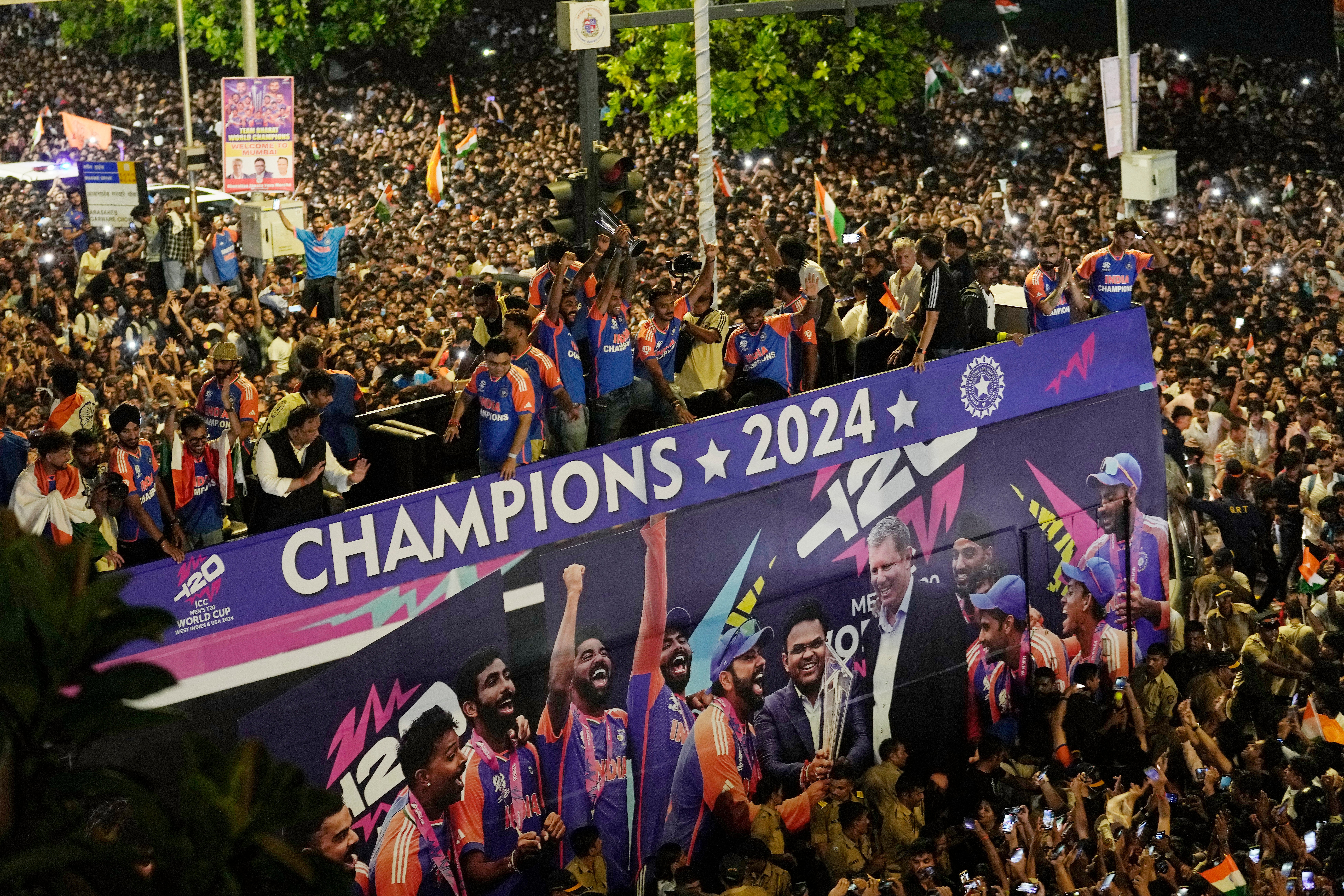 Fans surround a bus carrying India’s cricket team during a parade celebrating their T20 Cricket World Cup victory