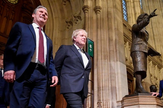 <p> Keir Starmer, left, and Boris Johnson pass a statue of former Prime Minister Margaret Thatcher as they walk through the Members' Lobby following the State Opening speech of Parliament at the Palace of Westminster in London, Tuesday, May 10, 2022</p>