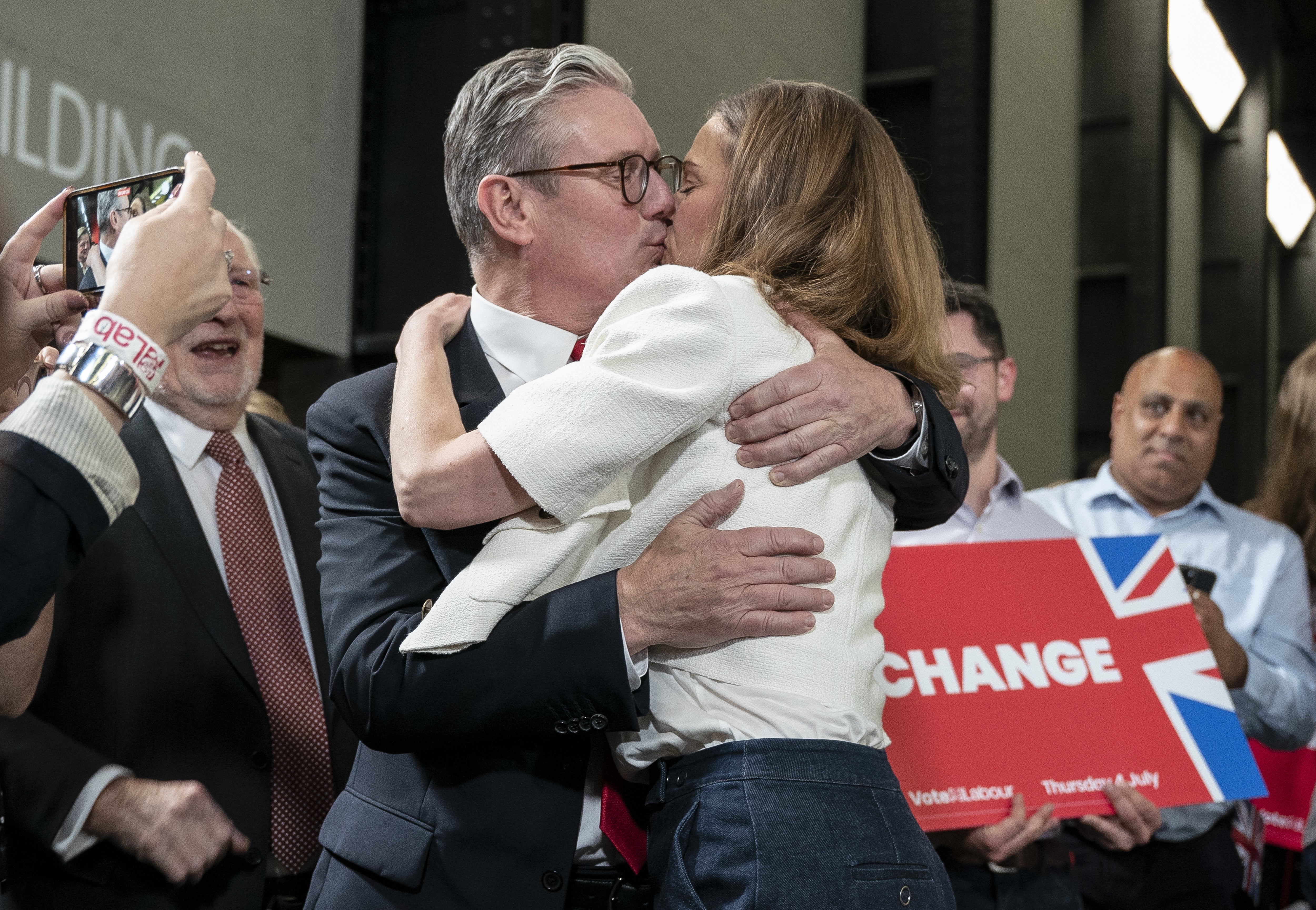 Sir Keir Starmer embraces his wife, Victoria, in front of cheering crowds in the Tate Modern’s Turbine Hall (Jeff Moore/PA)