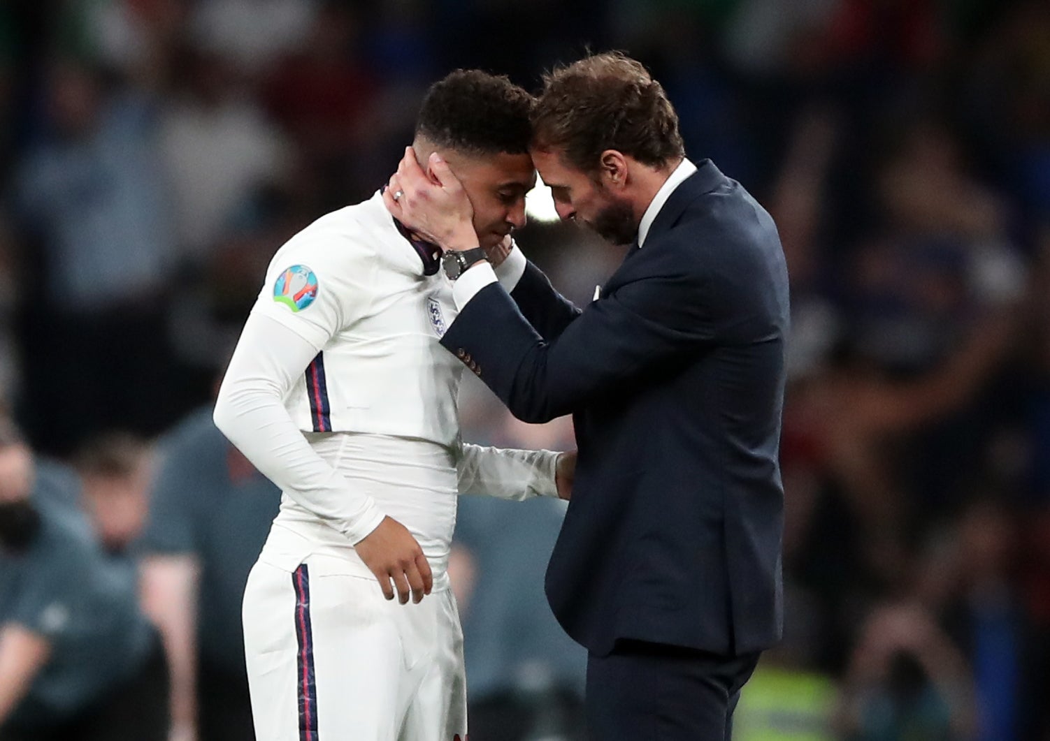 England manager Gareth Southgate consoles Jadon Sancho following defeat in the penalty shoot-out to Italy in the Euro 2020 final. (Nick Potts/PA)