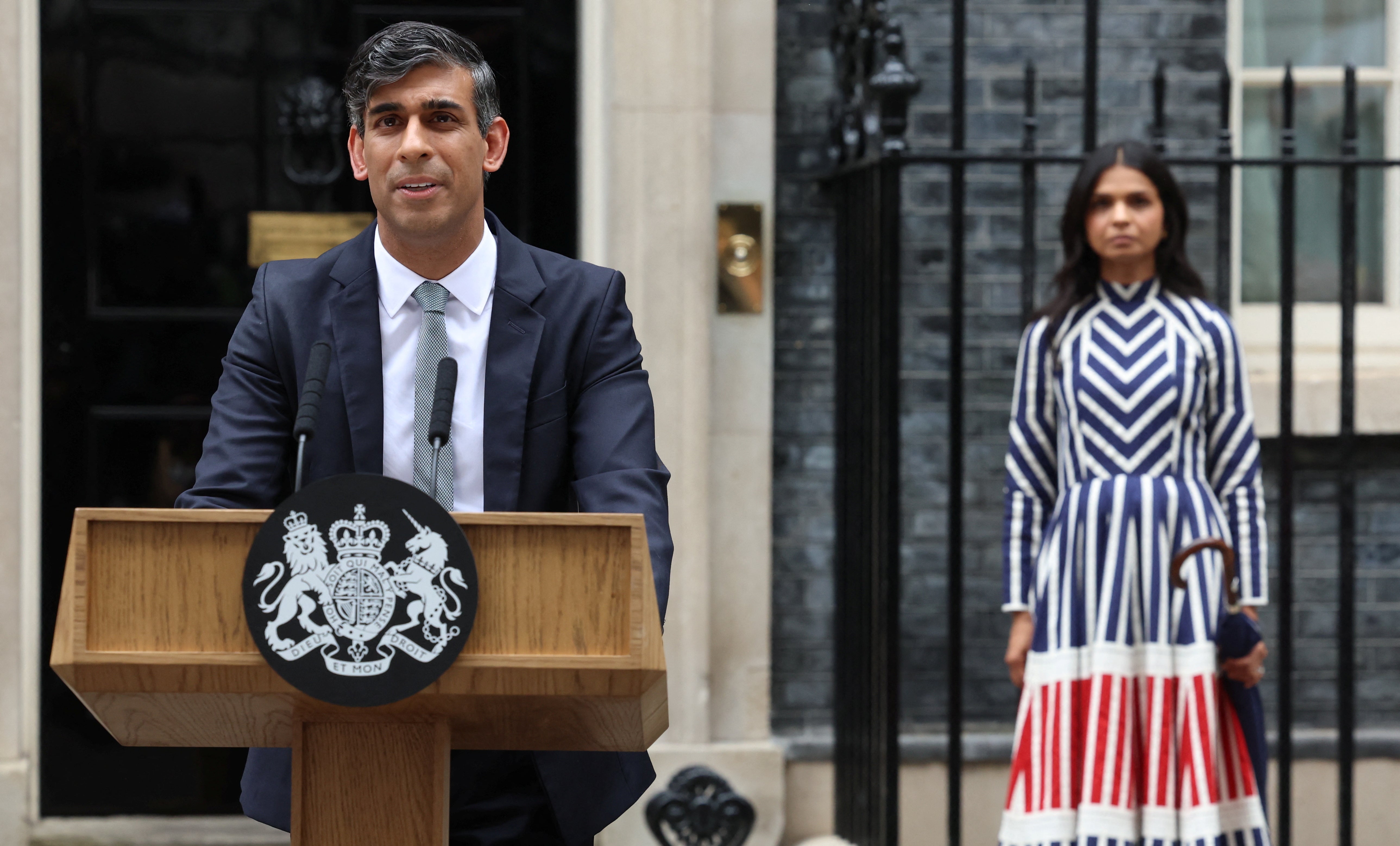 Outgoing British Prime Minister Rishi Sunak, flanked by his wife Akshata Murty, delivers a speech at Number 10 Downing Street