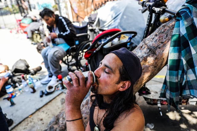 <p>A homeless man named Angel drinks a soda to keep cool during a heatwave in San Francisco on July 3</p>